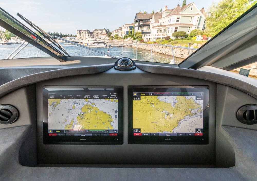 Cockpit view of 2022 Riviera 6000 Sport Yacht Platinum with navigation screens.