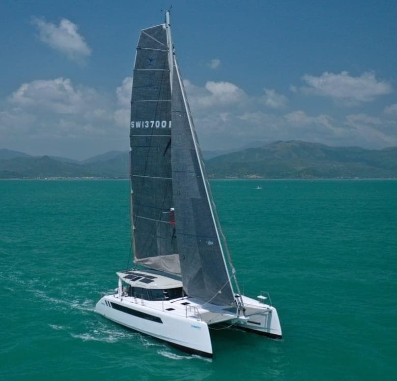 2025 Seawind 1370 catamaran sailing on turquoise waters under a clear sky.