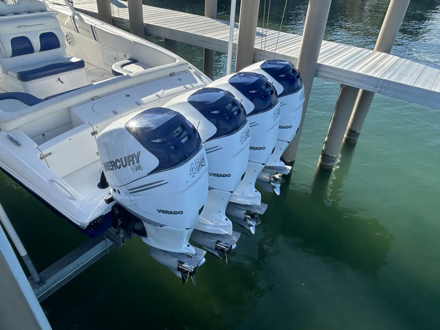 2016 Midnight Express 37 Open boat with four Mercury Verado outboard engines docked.