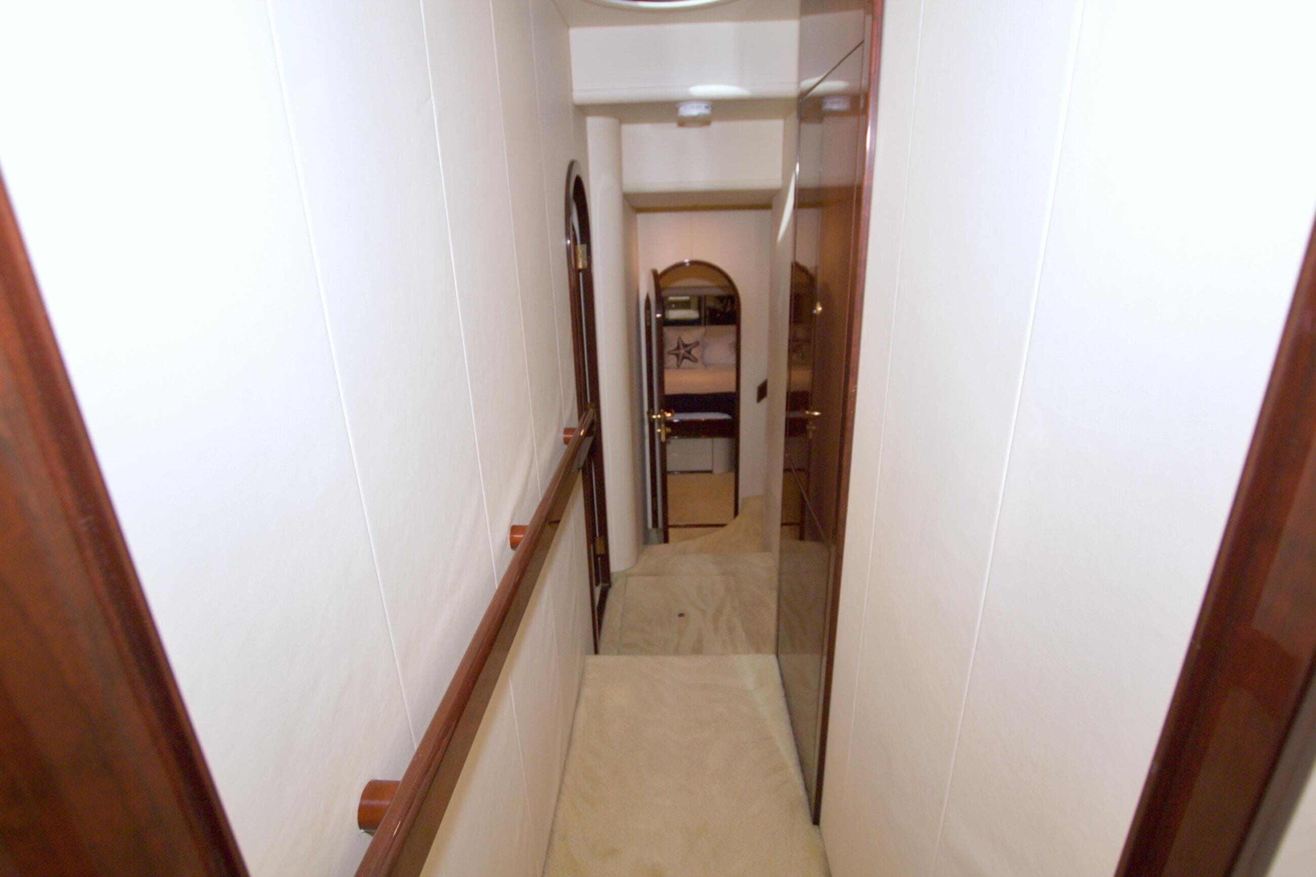 Hallway inside 2005 Neptunus 62 Flybridge yacht, featuring wooden accents and modern design.