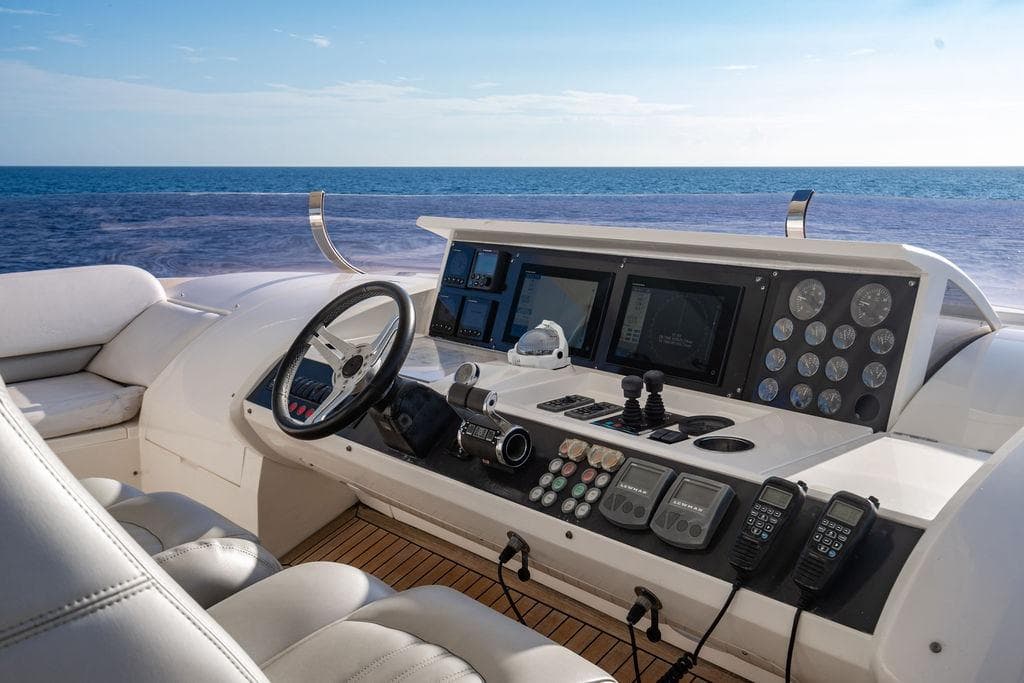 Helm of 2010 Princess 95 Motor Yacht with ocean view, featuring advanced navigation controls.