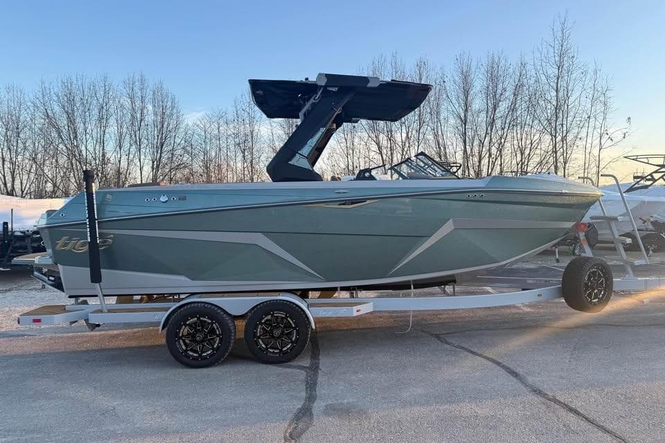 2026 Tigé Z3 boat on trailer, parked outdoors with trees in background.