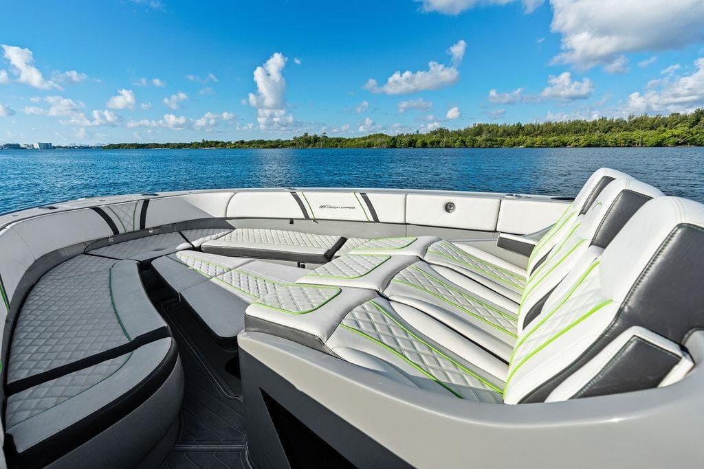 Luxurious seating on 2022 Midnight Express 43' Solstice boat, with scenic water view.