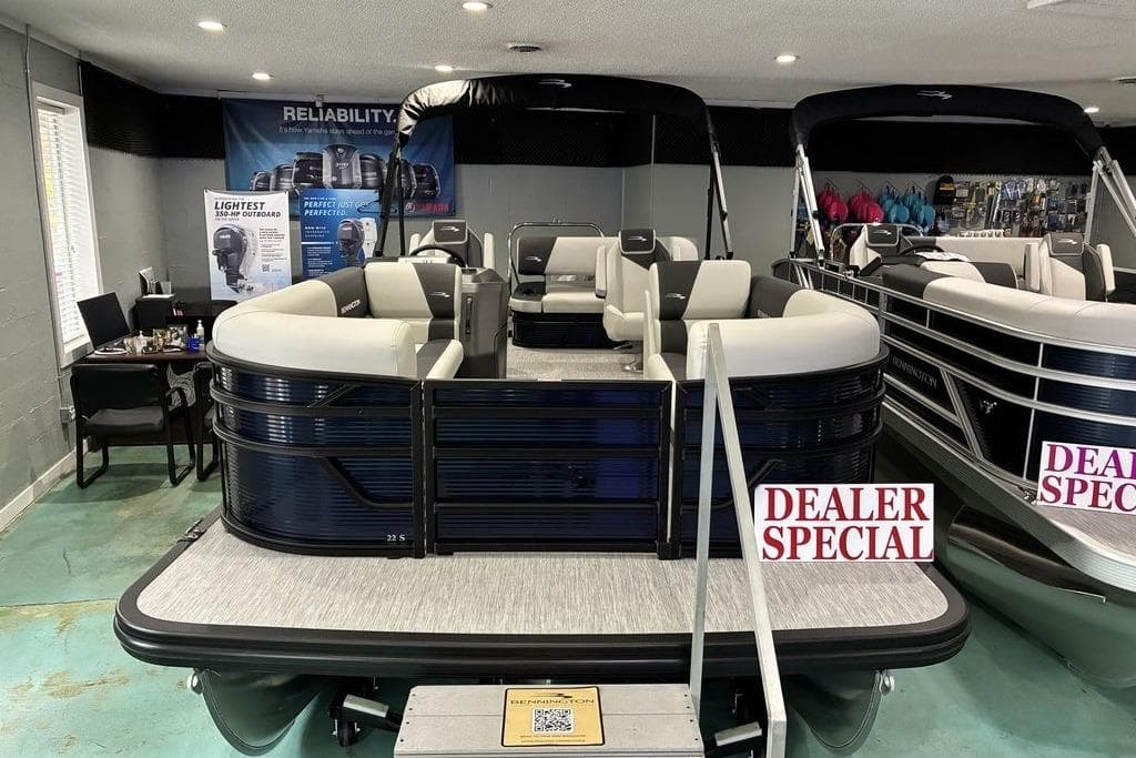 2026 Bennington S Swingback 22 SSB SPS pontoon boat on display with dealer special signs.