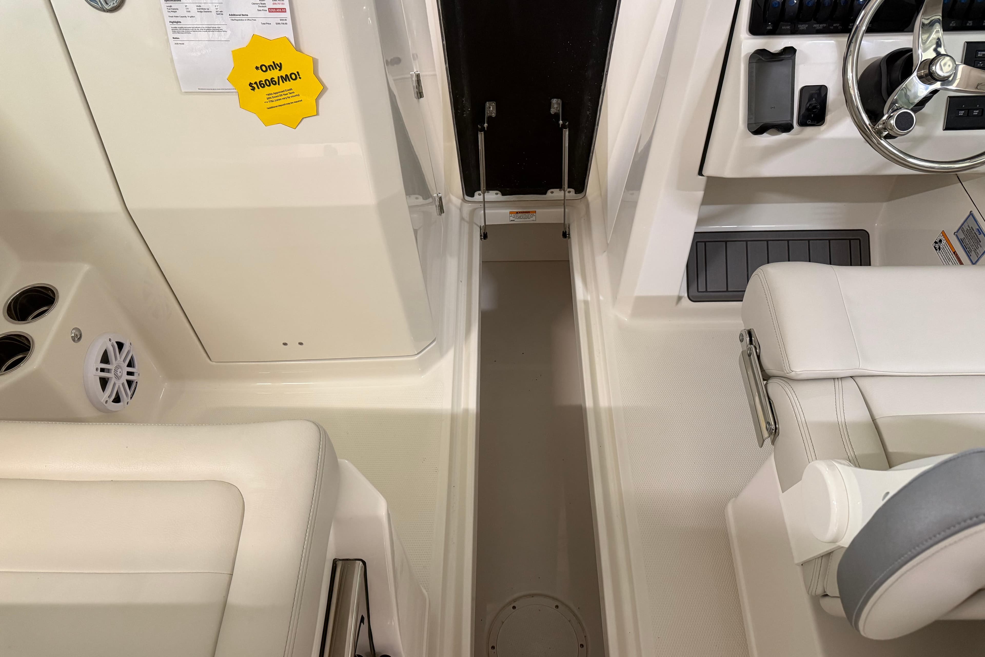 2026 Sailfish 276 DC boat interior with steering wheel and seating area.