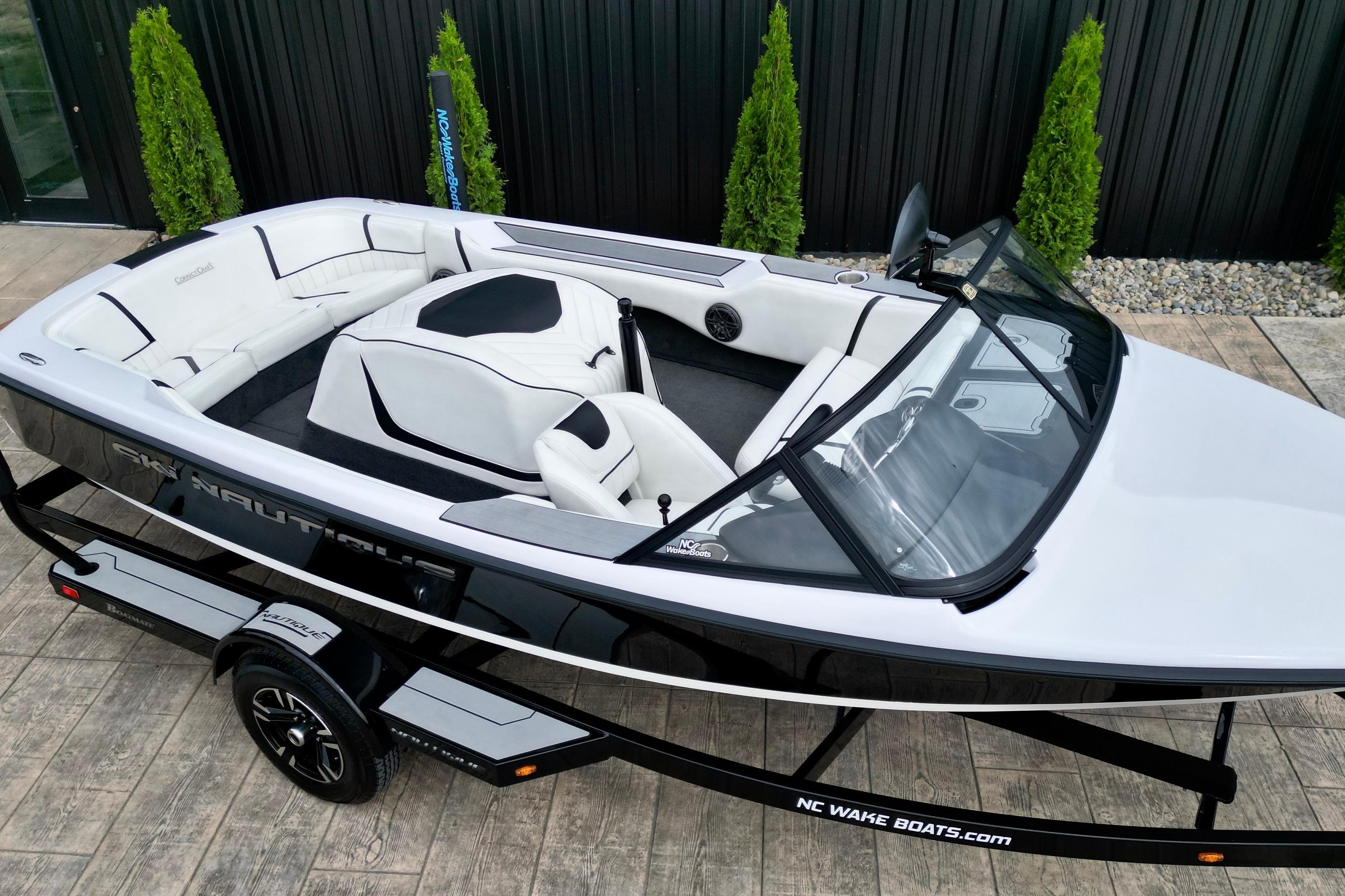 1994 Nautique Ski Nautique boat with sleek black and white design on a trailer.
