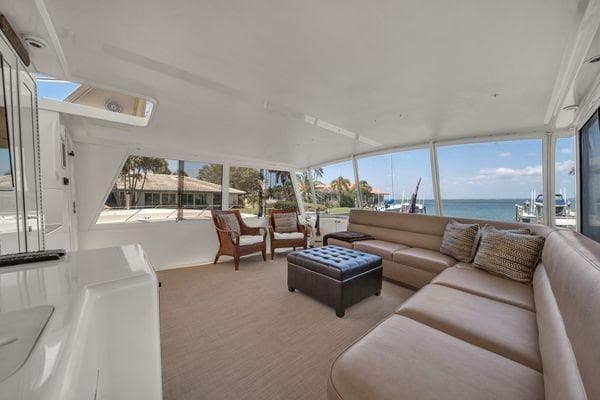 Spacious interior of a 1993 Viking Convertible yacht with comfortable seating and ocean view.