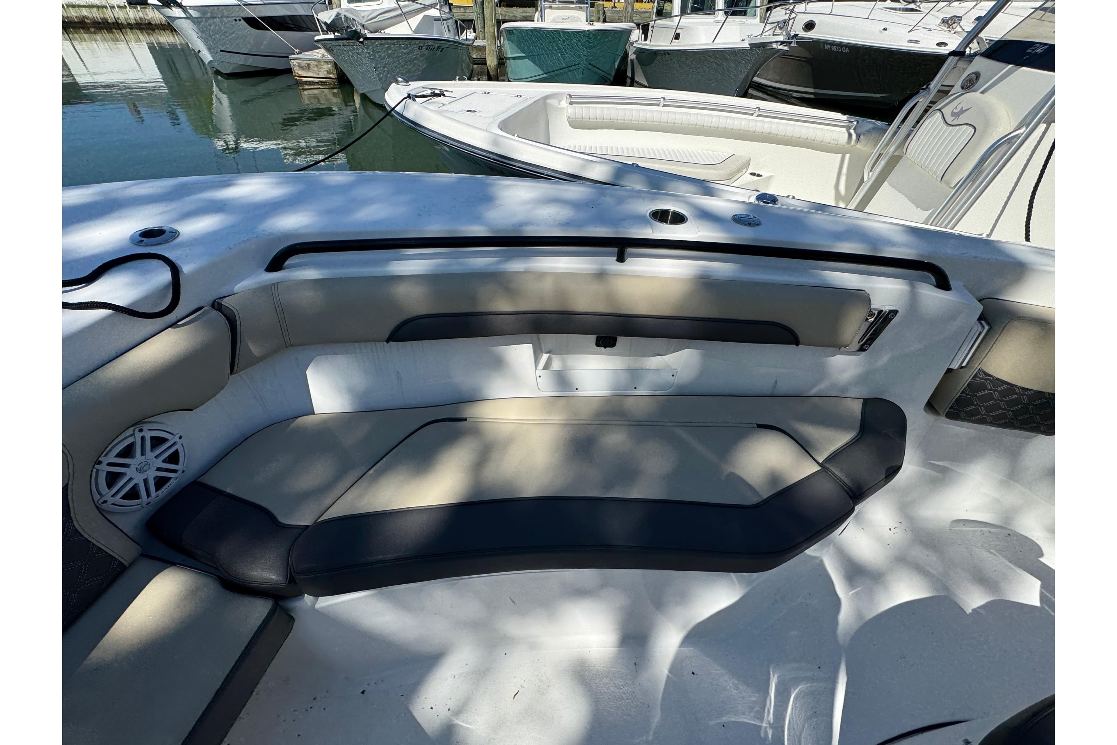 2022 Tidewater 256 CC Adventure boat interior with cushioned seating and speaker.