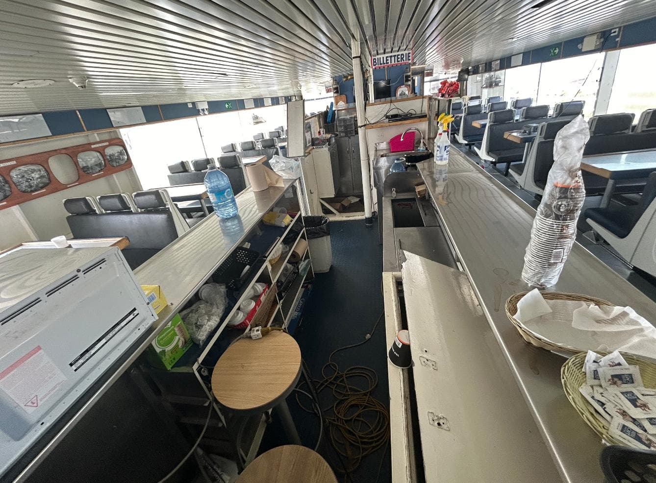 Interior of a 1997 CNM Evolution ferry with seating and a small bar area.