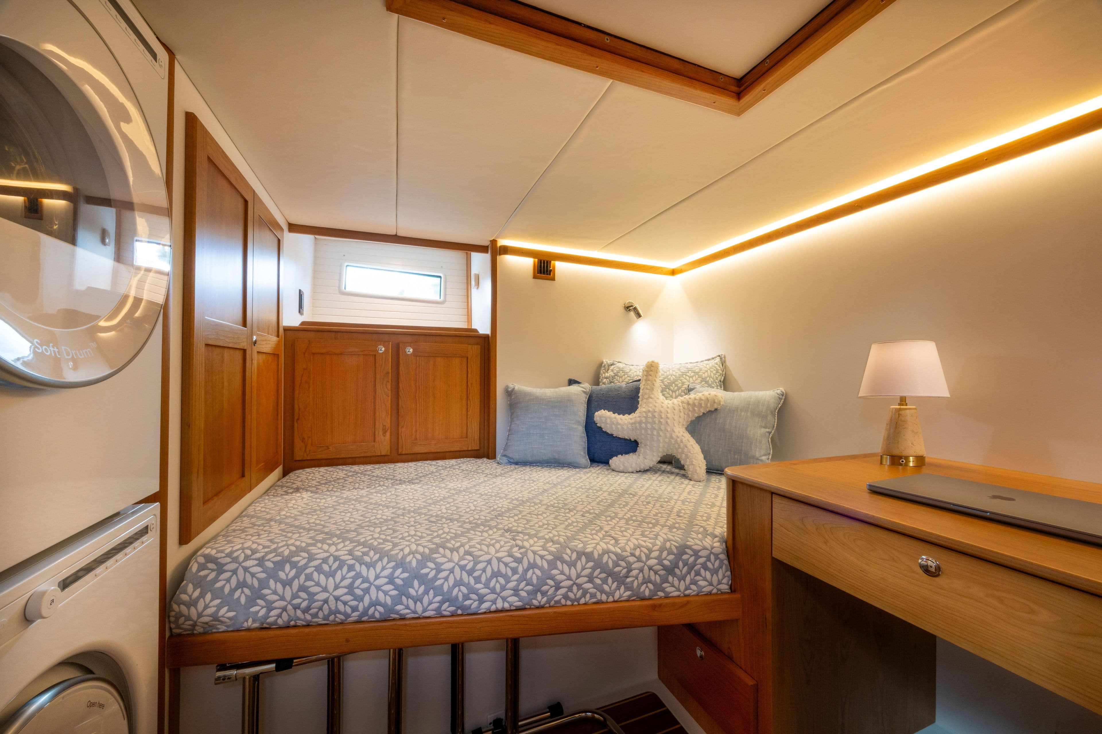 Luxurious cabin interior of 2027 Sabre 51 Salon Express with cozy bed and modern decor.