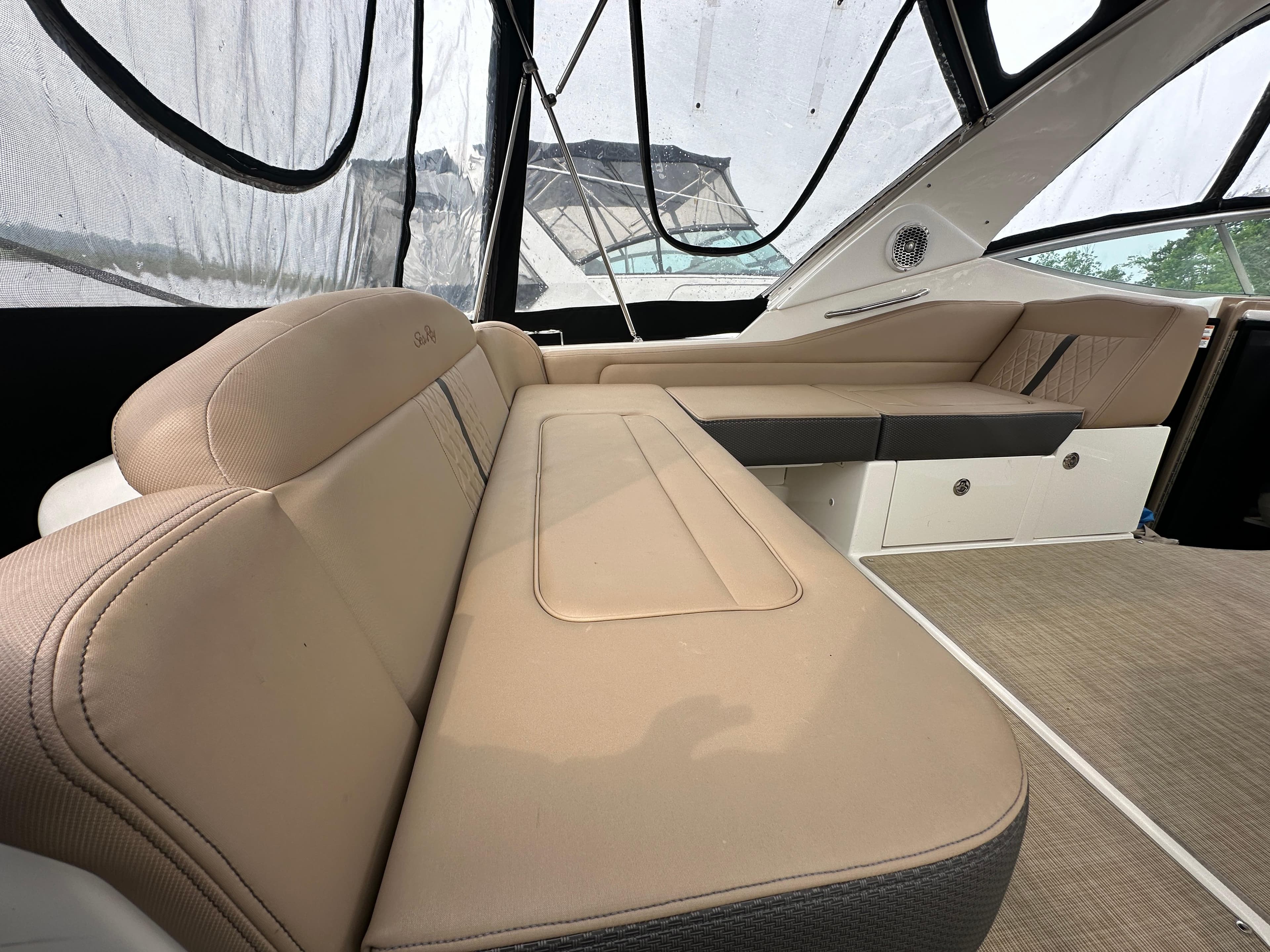 2017 Sea Ray Sundancer 310 interior with beige seating and modern design.