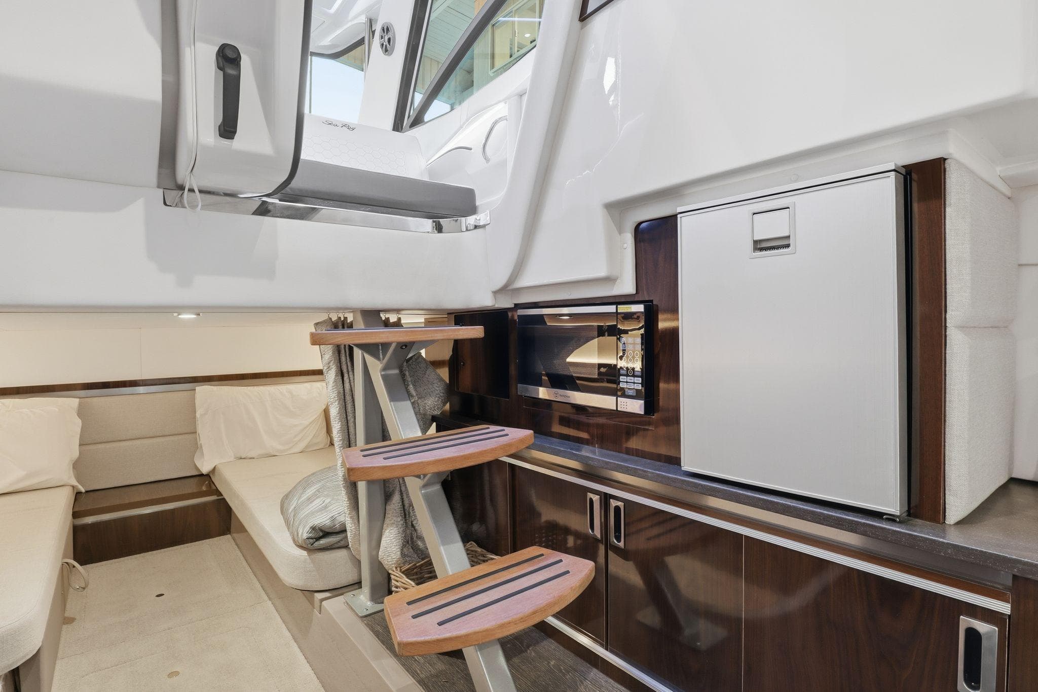 2019 Sea Ray Sundancer 320 interior with kitchenette, seating, and modern design.