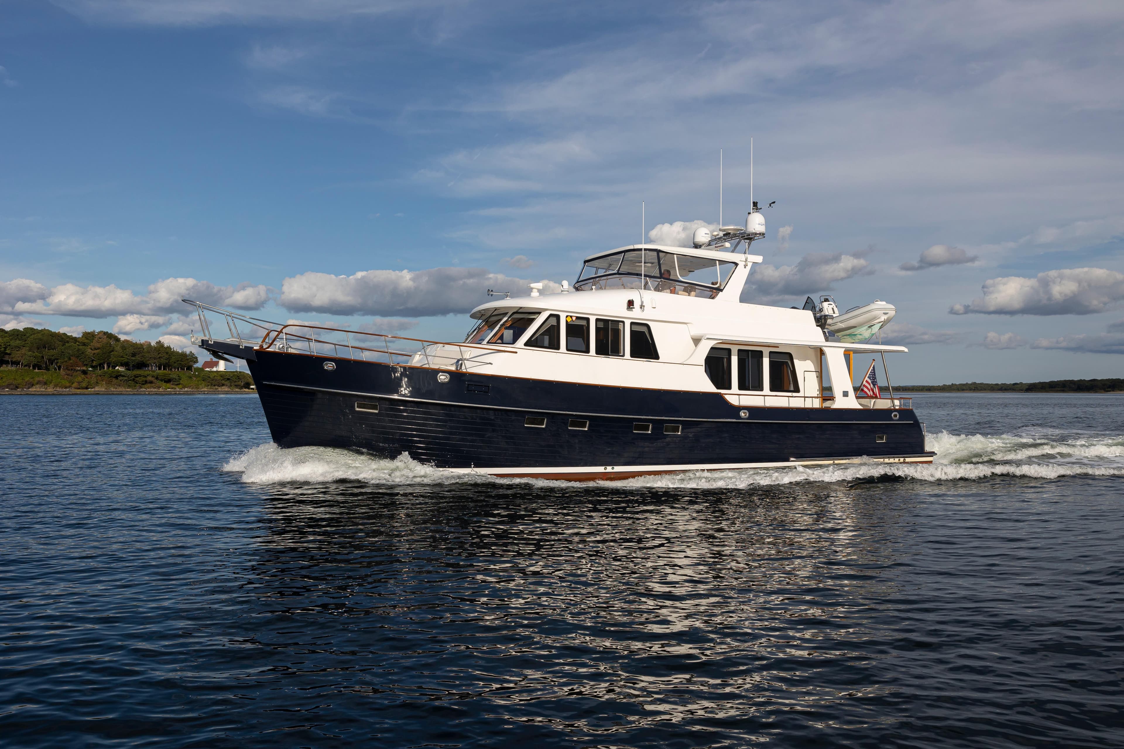 2006 Grand Banks 59 Aleutian RP yacht cruising on open water under a blue sky.