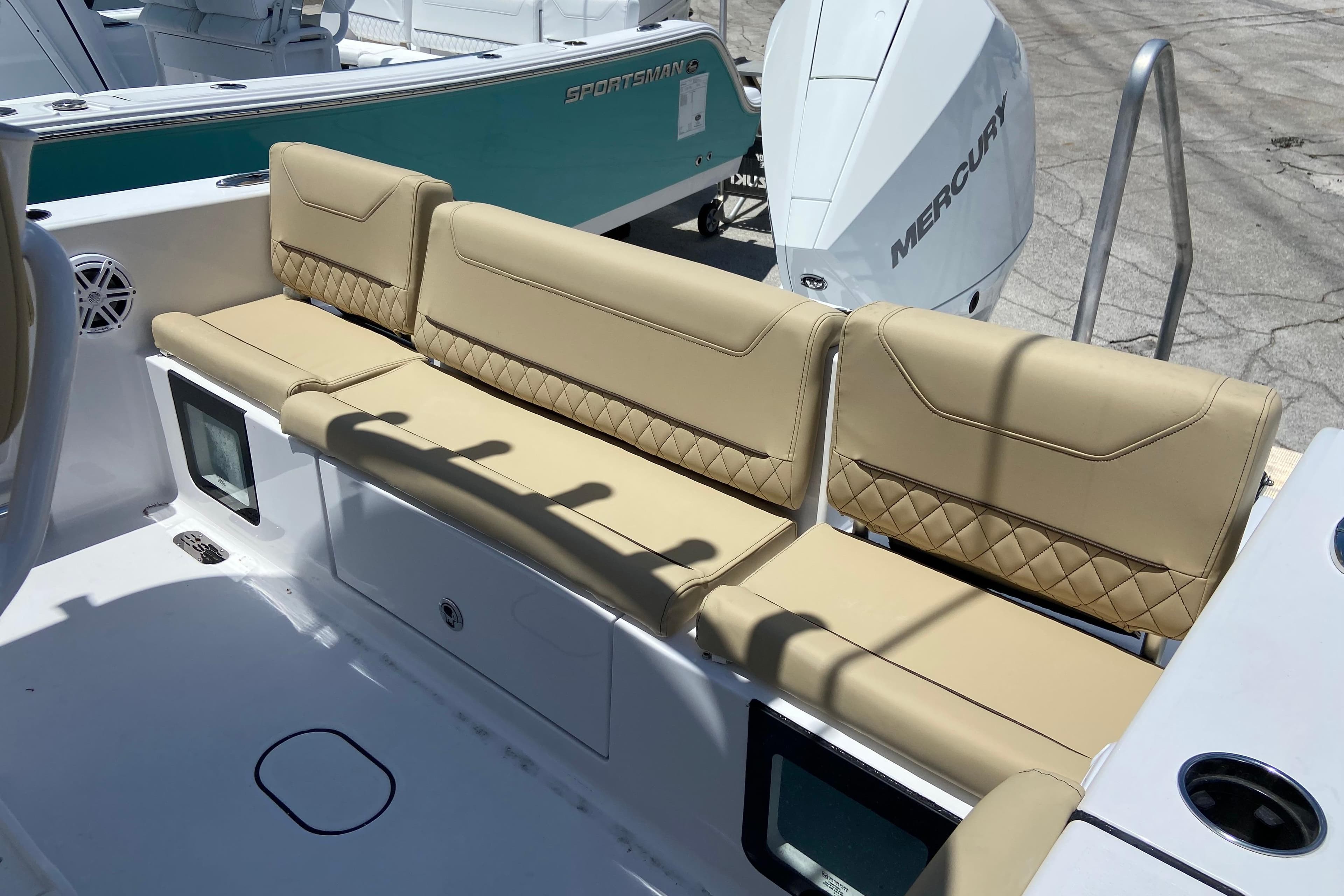 2026 Sportsman Heritage 231 Center Console boat with tan seating and Mercury engine.