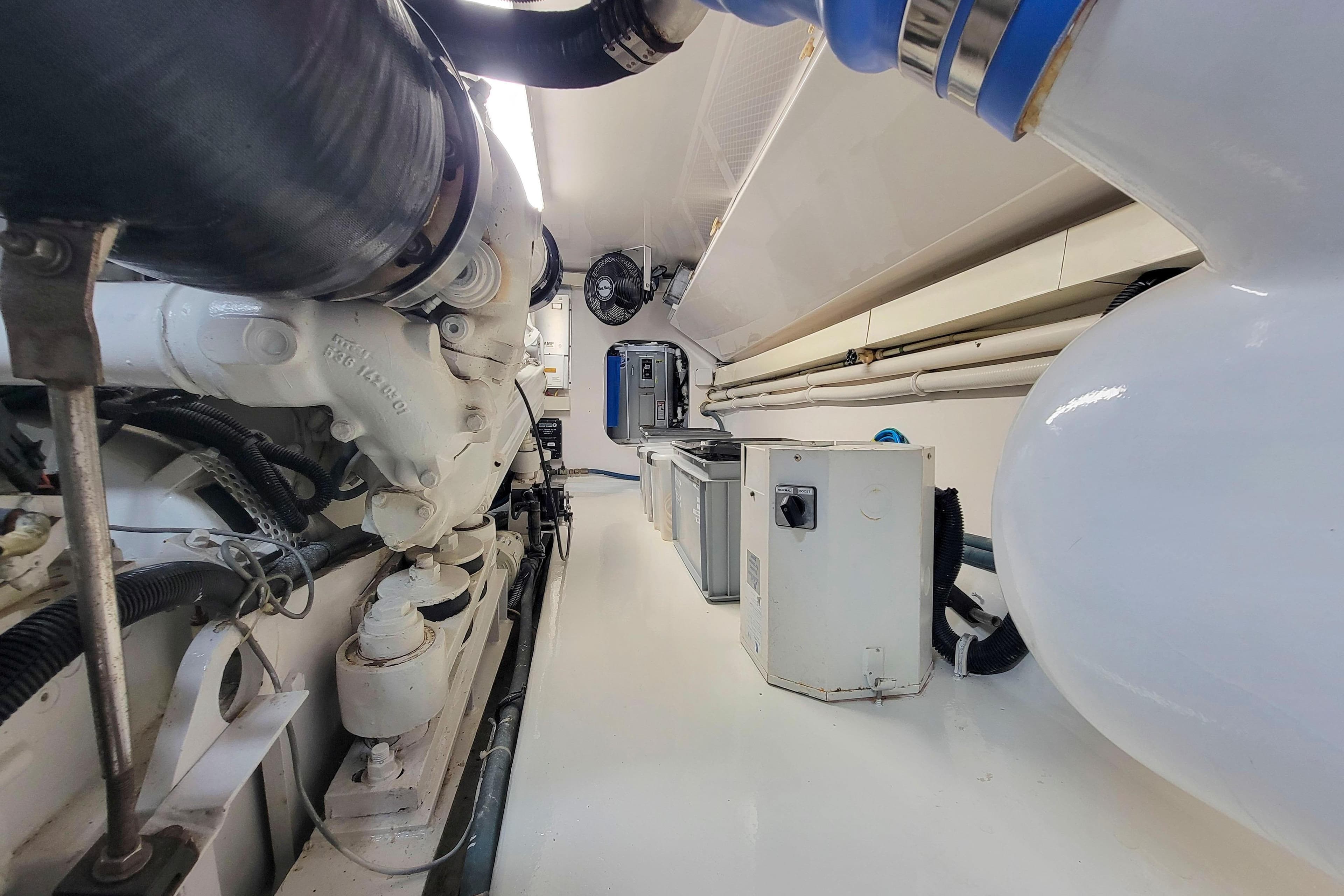 Engine room of 2002 Viking 65 Enclosed Bridge yacht, showcasing machinery and equipment.