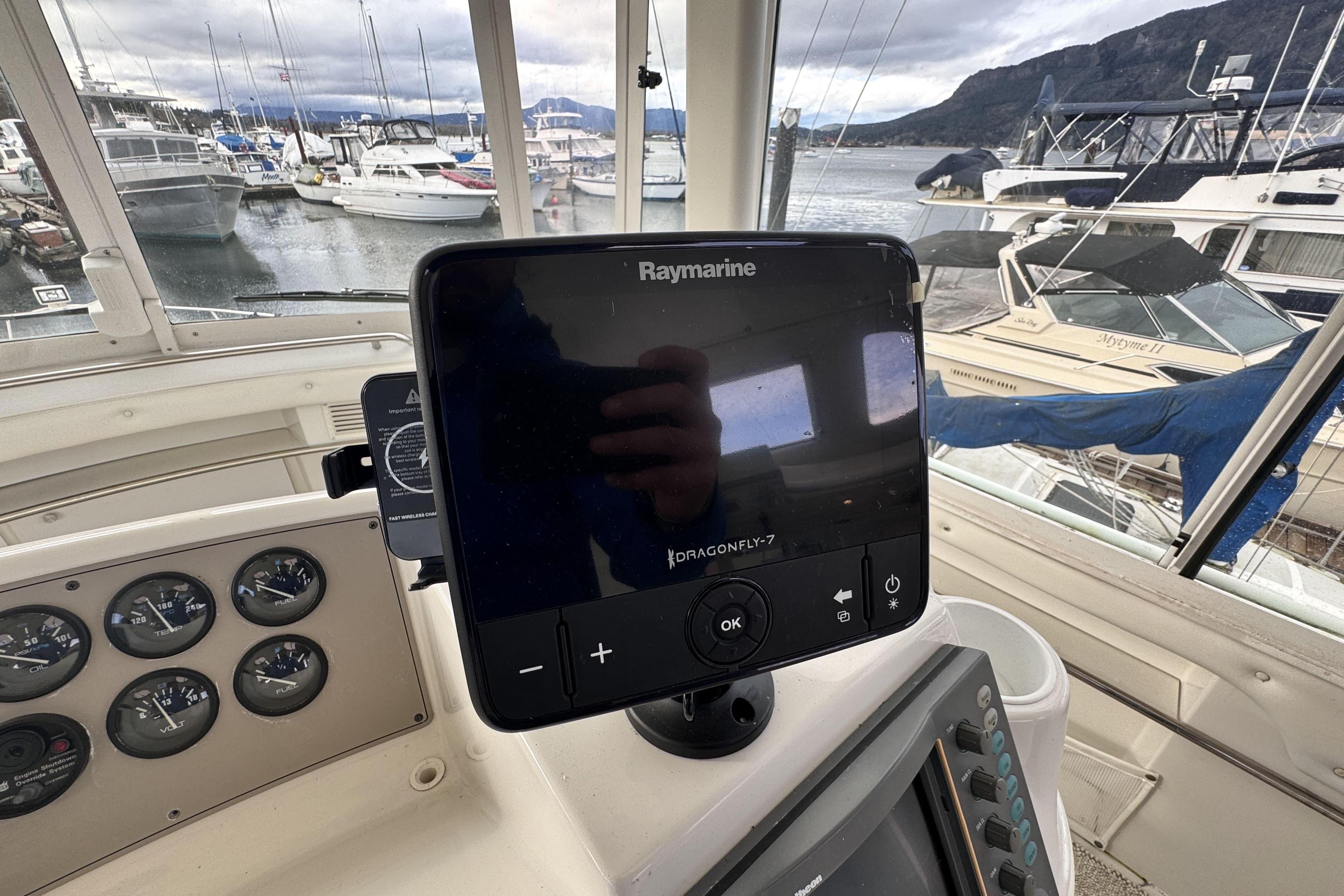 Raymarine Dragonfly-7 display on 1997 Carver 500 Cockpit Motor Yacht dashboard, marina view.