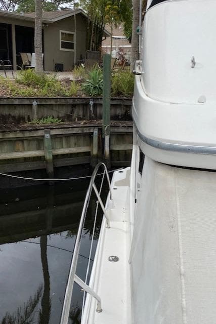 2007 Silverton 33 Convertible docked near a waterfront home.