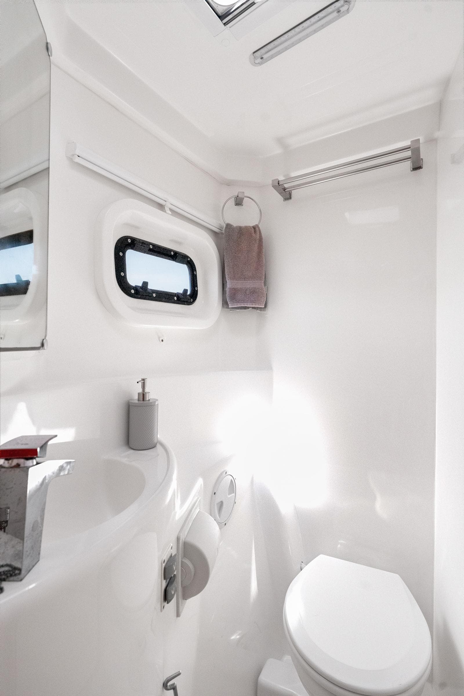 Modern bathroom in 2016 Leopard 44 Owners Version yacht, featuring sleek white design and compact fixtures.