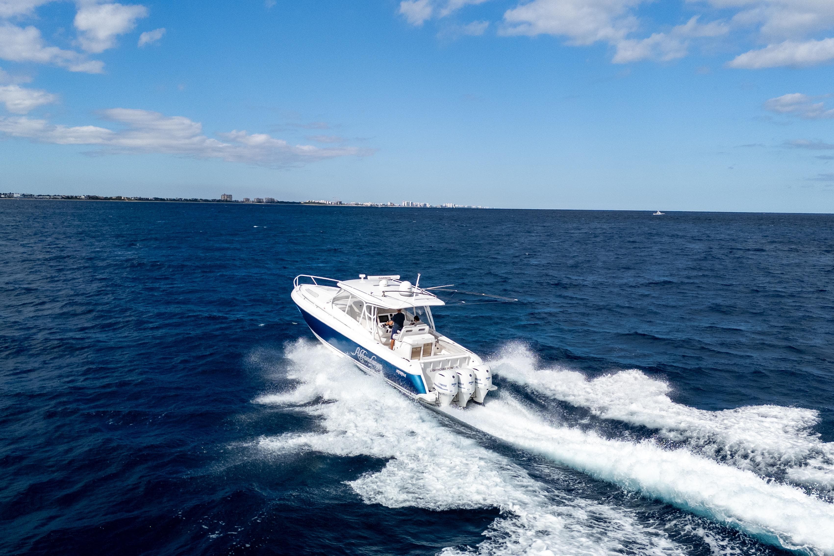2019 Intrepid 407 Cuddy cruising on open ocean under blue sky.