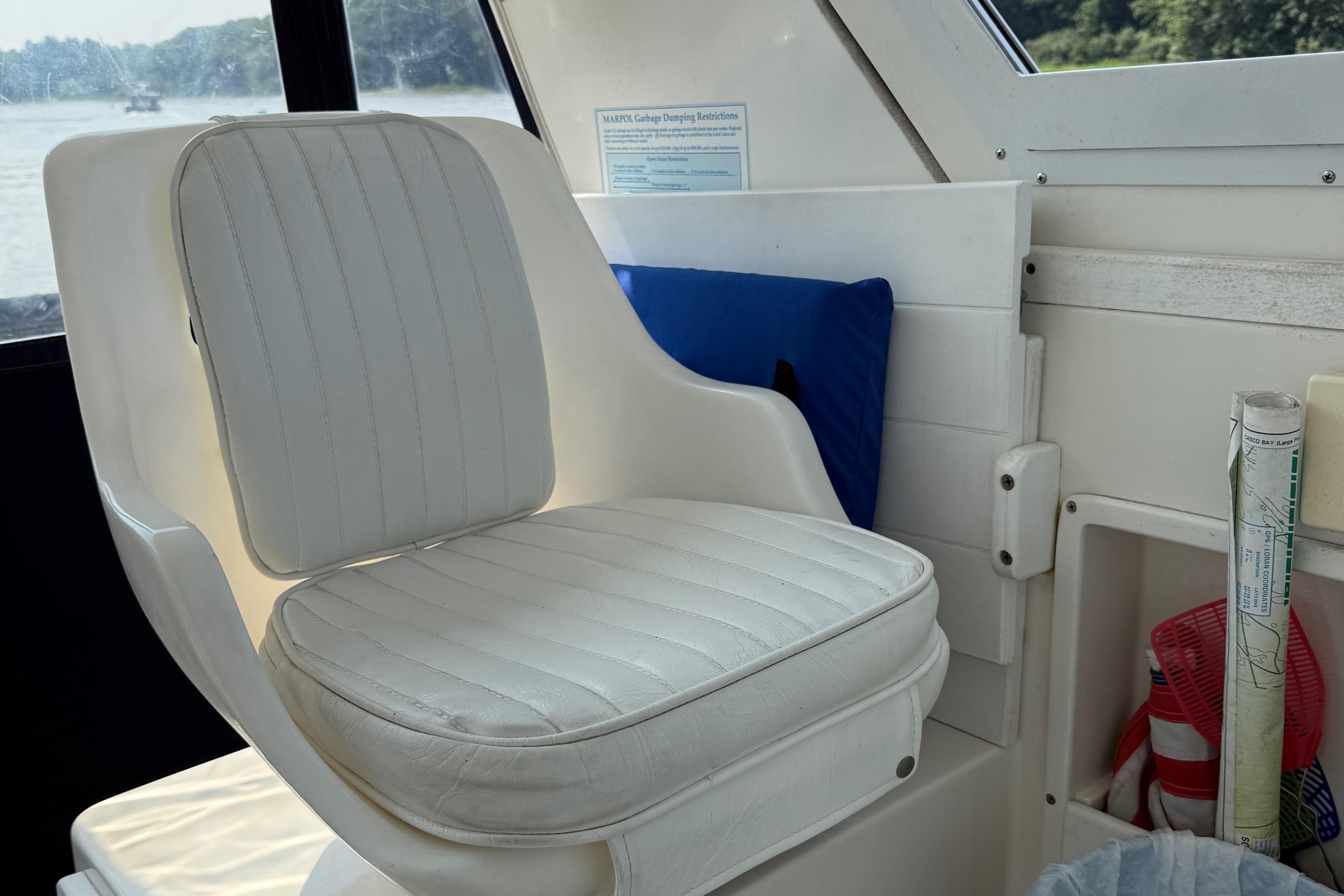 1994 Albin 28 Tournament Express interior with white cushioned seat and window view.
