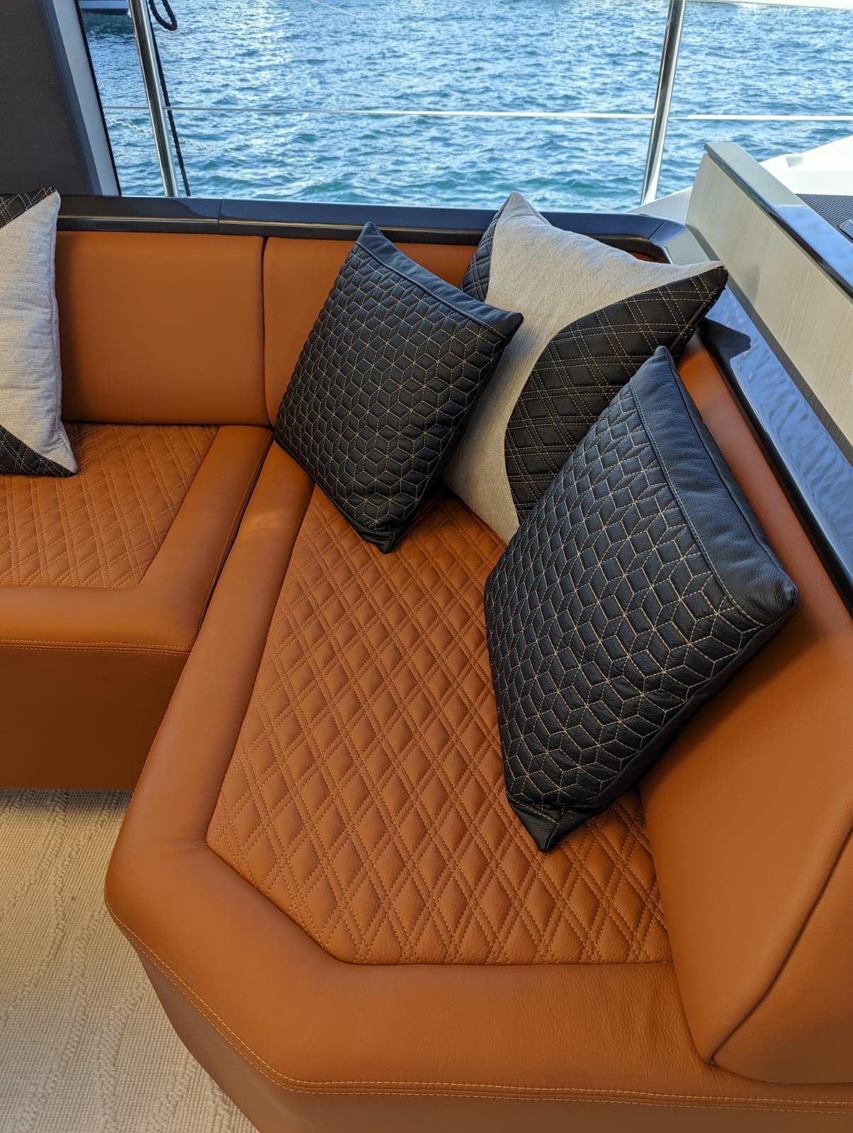 Luxurious leather seating on 2023 Astondoa 677 Coupe yacht with quilted cushions.