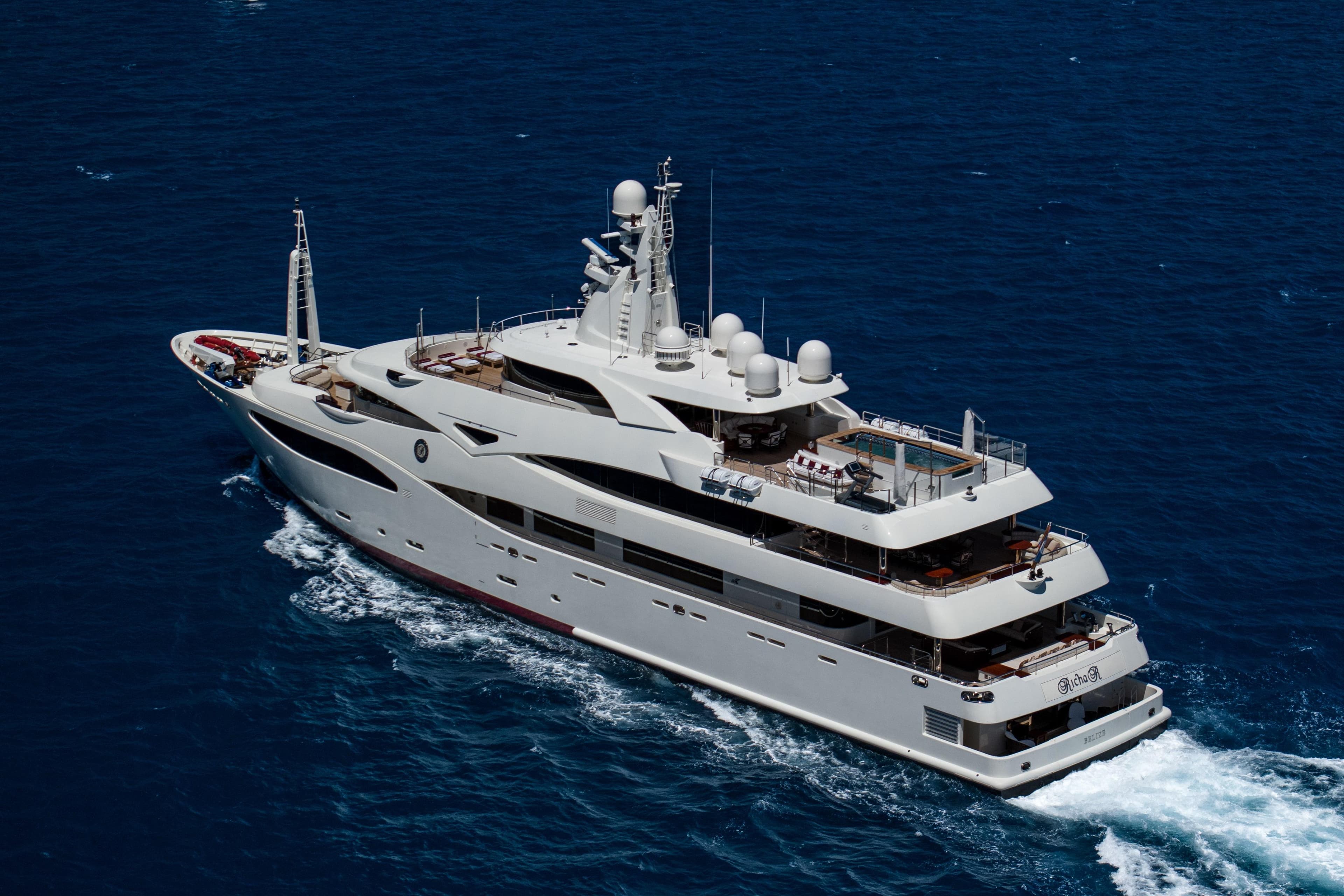 Luxurious 2008 CRN 185 yacht cruising on open blue sea.