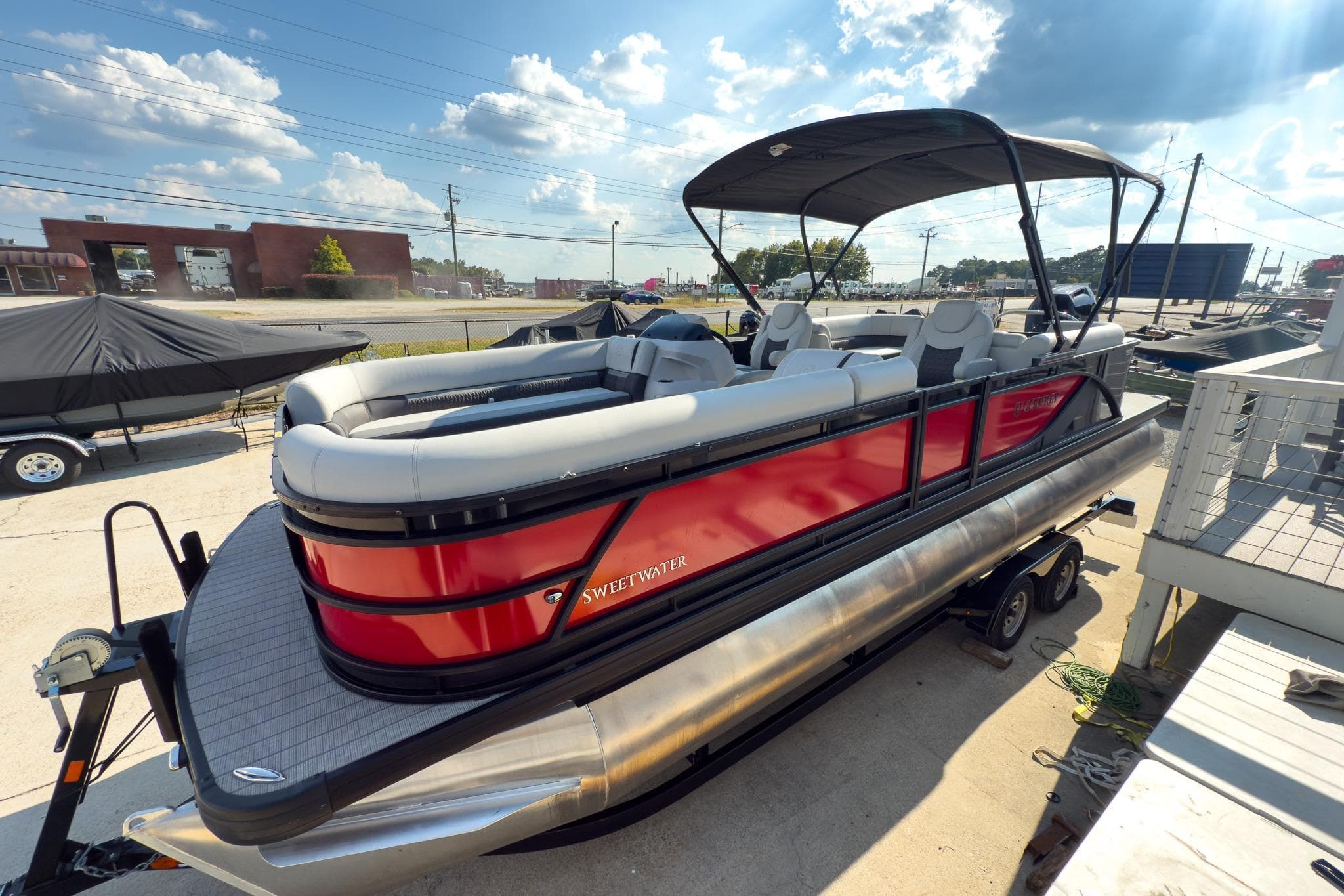 2024 Godfrey Sweetwater 22' pontoon boat with red exterior and split bench seating.