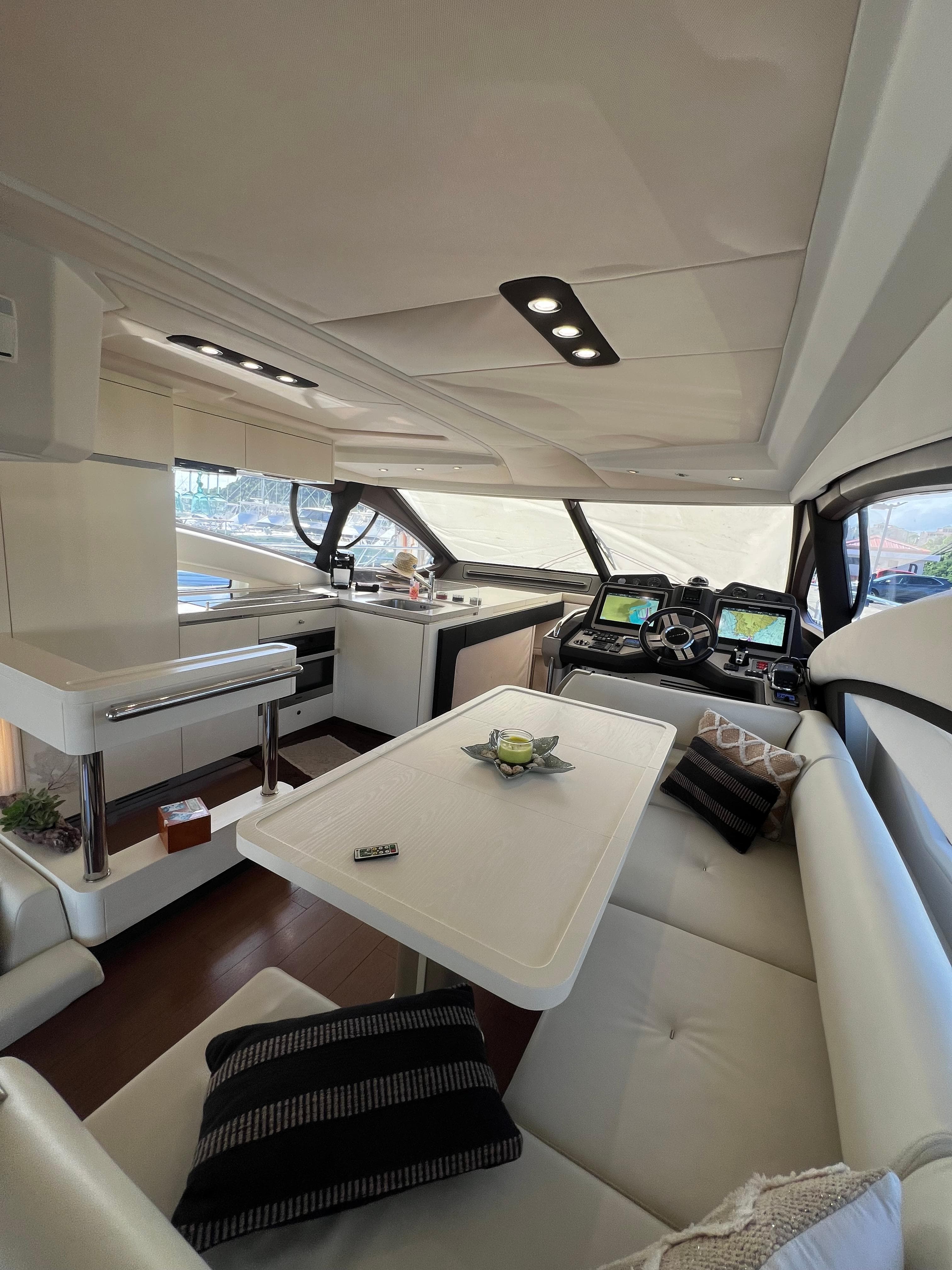 Luxurious interior of a 2016 Azimut 54fly yacht with modern seating and navigation equipment.