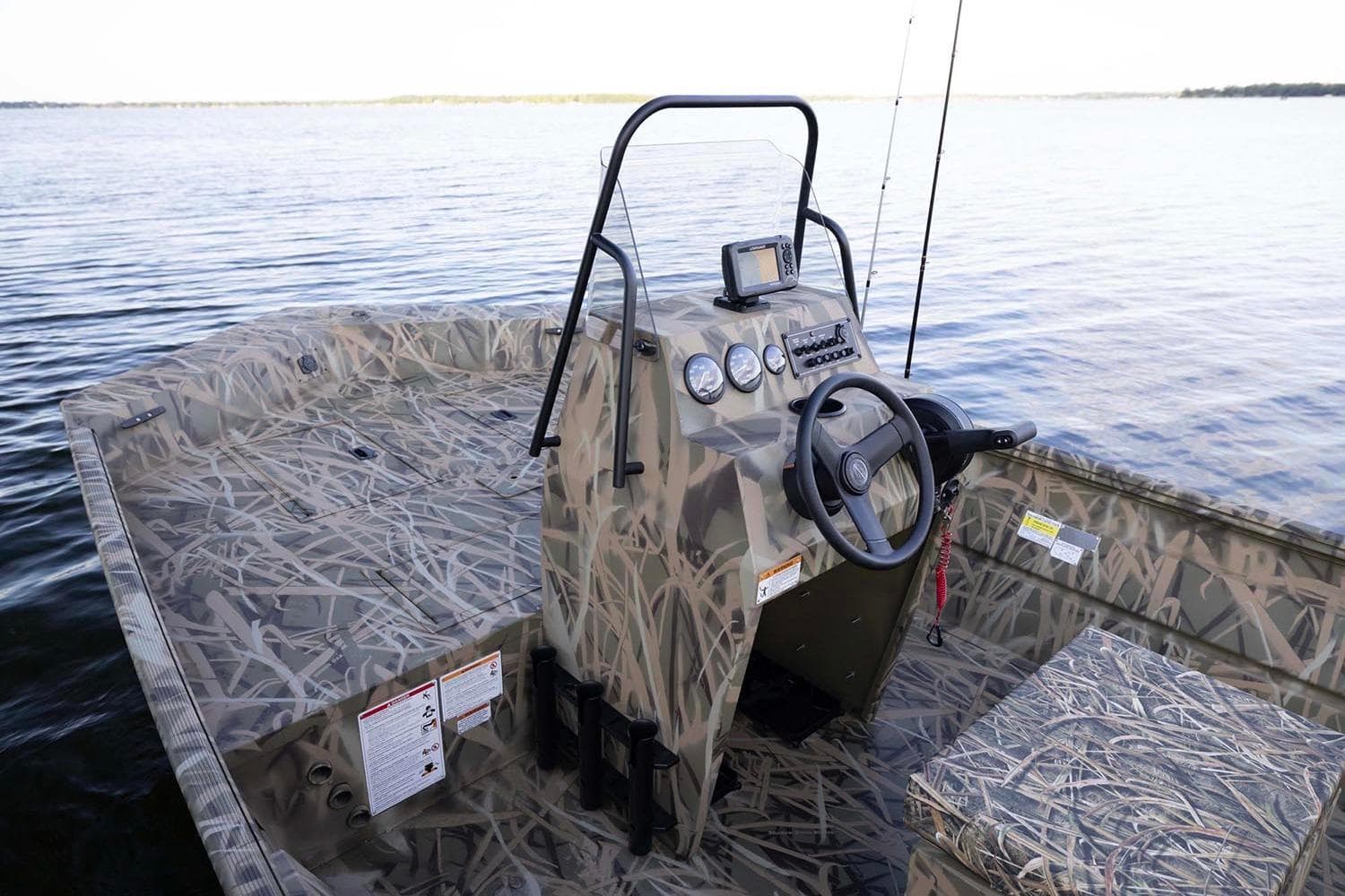 Manufacturer Provided Image: 2026 Crestliner 1660 Retriever FCC boat with camouflage design on a serene lake.