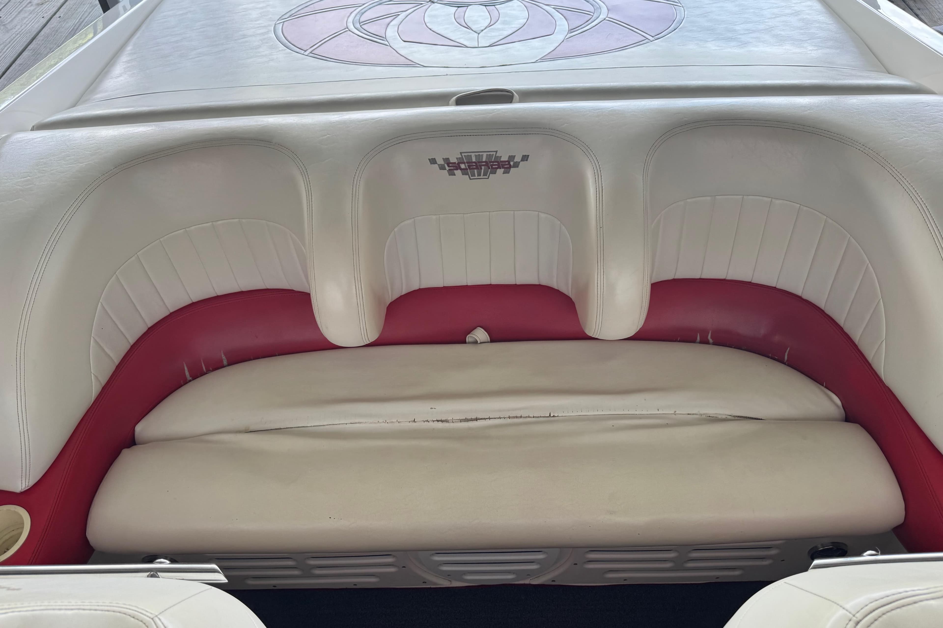 1997 Wellcraft 29 Scarab boat interior with white and red seating.