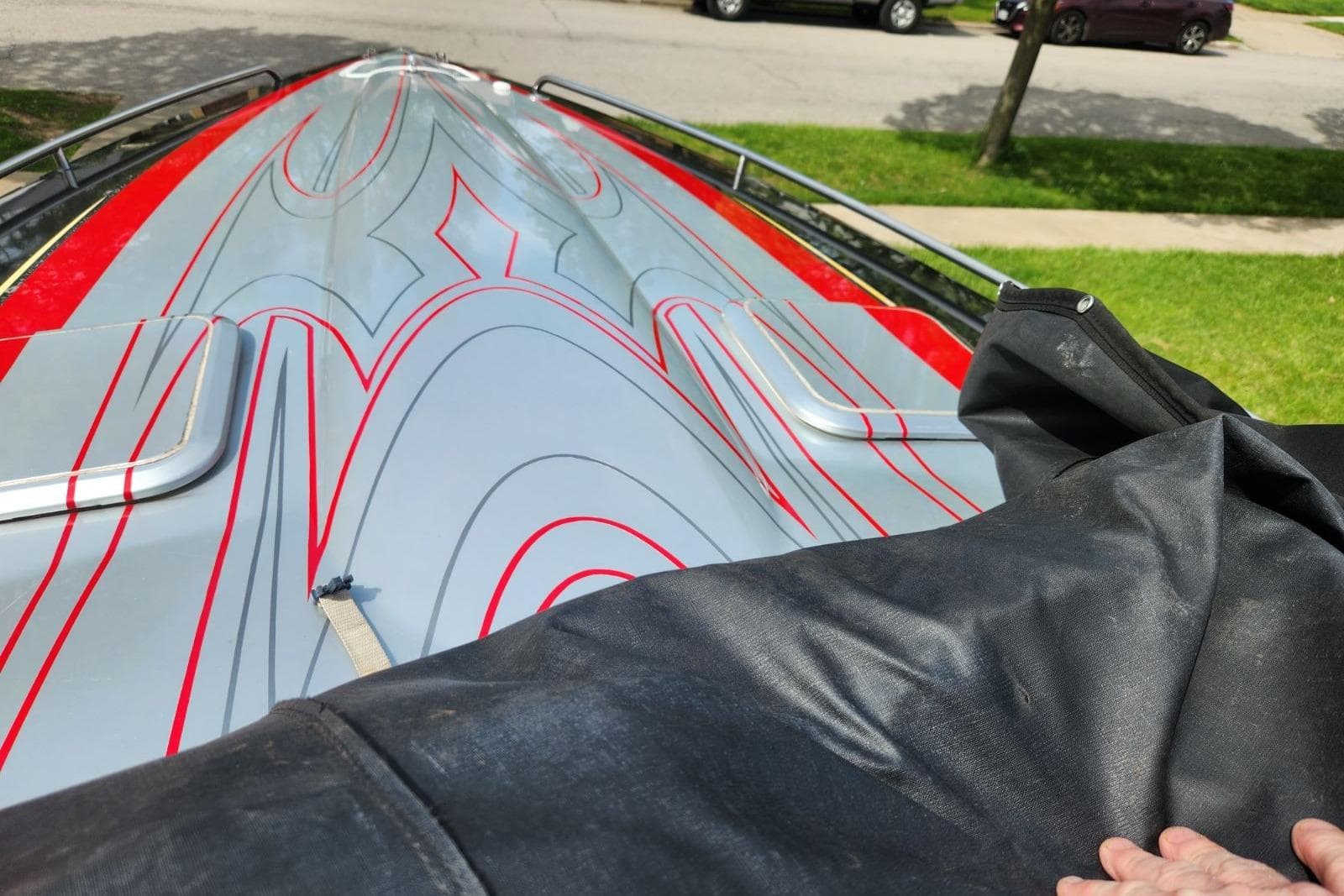 2008 Formula 292 FASTech boat with sleek red and gray design, partially covered.