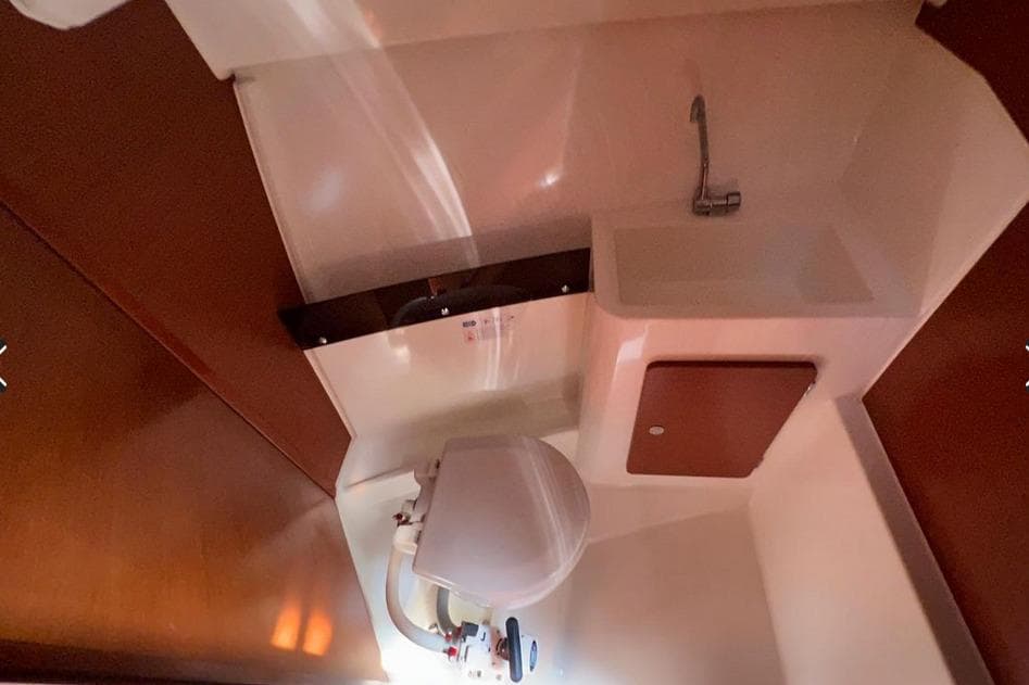 Interior of 2017 Jeanneau Merry Fisher 795 boat bathroom with sink and toilet.