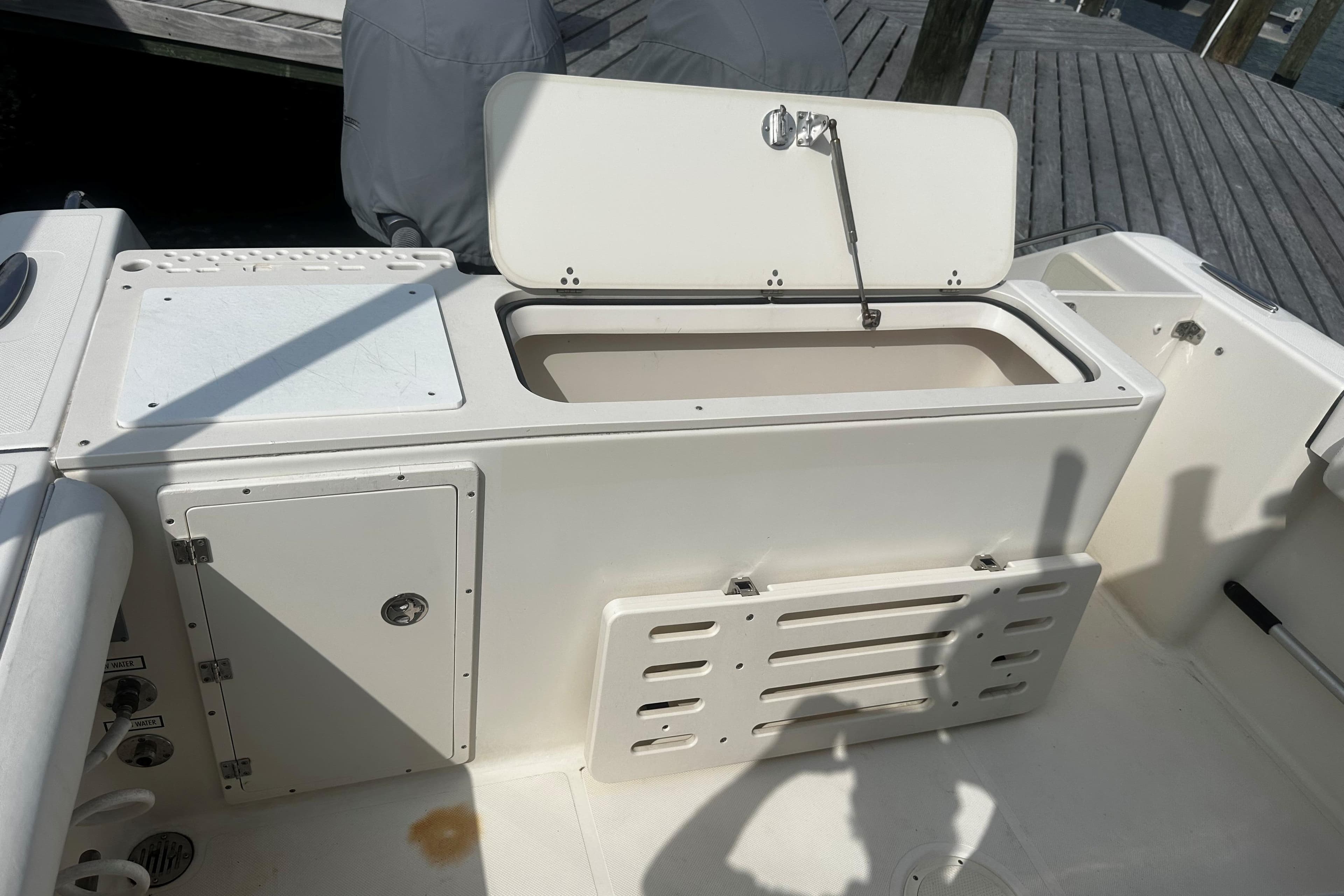 Open storage compartment on a 2006 Pursuit 2570 Center Console boat.