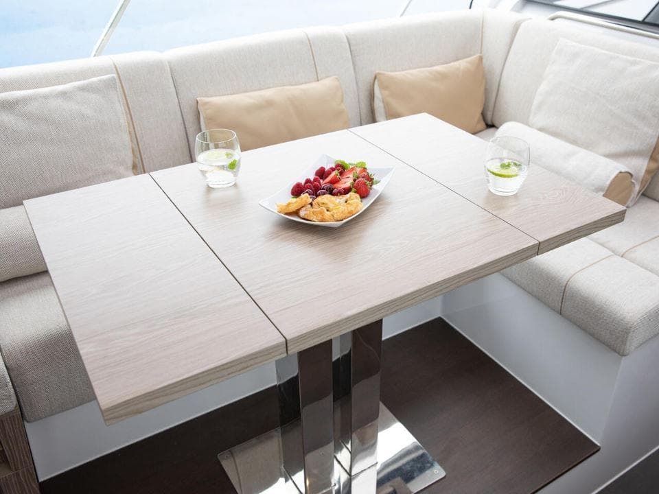 Luxurious interior of 2025 Sealine C390 yacht with elegant dining setup.