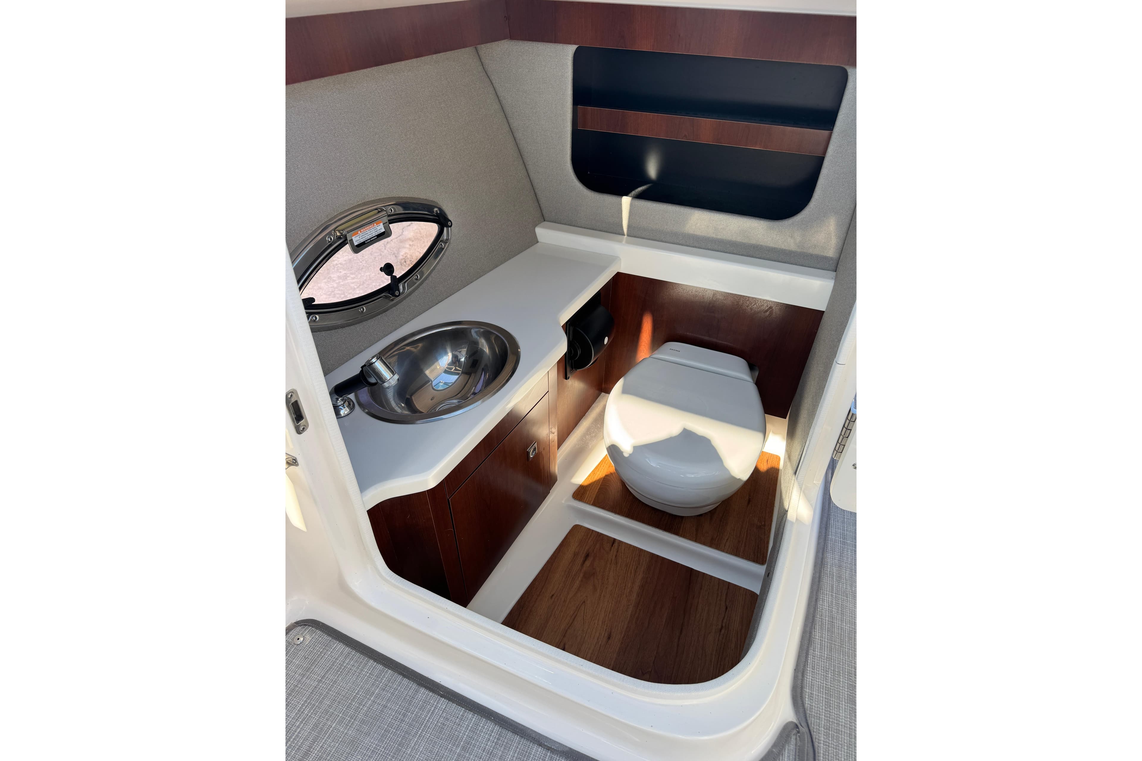 2019 Chaparral 297 SSX boat interior with sink and toilet in compact bathroom.