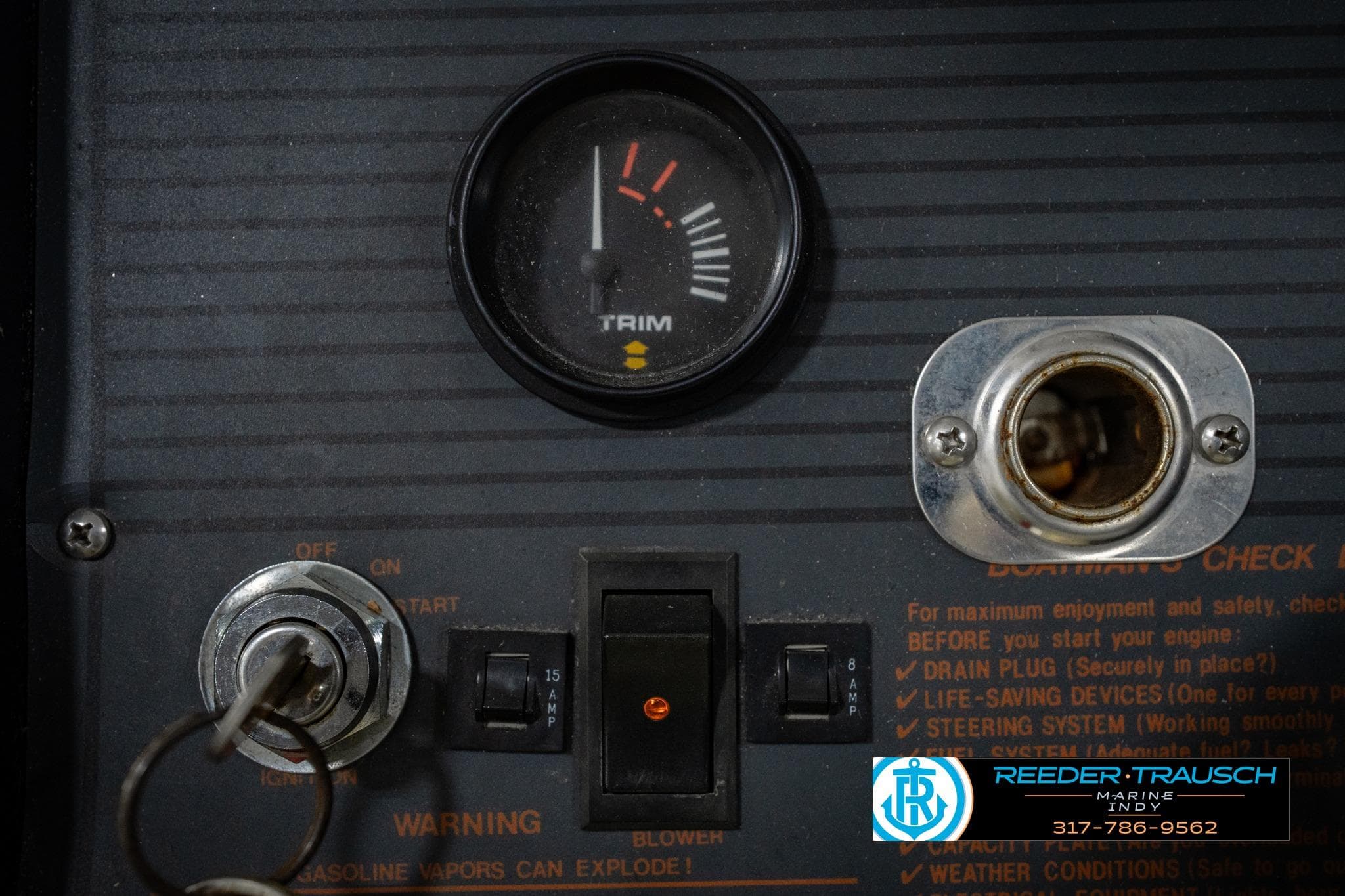 Dashboard of a 1986 Regal Sebring 195 boat with trim gauge and ignition switch.