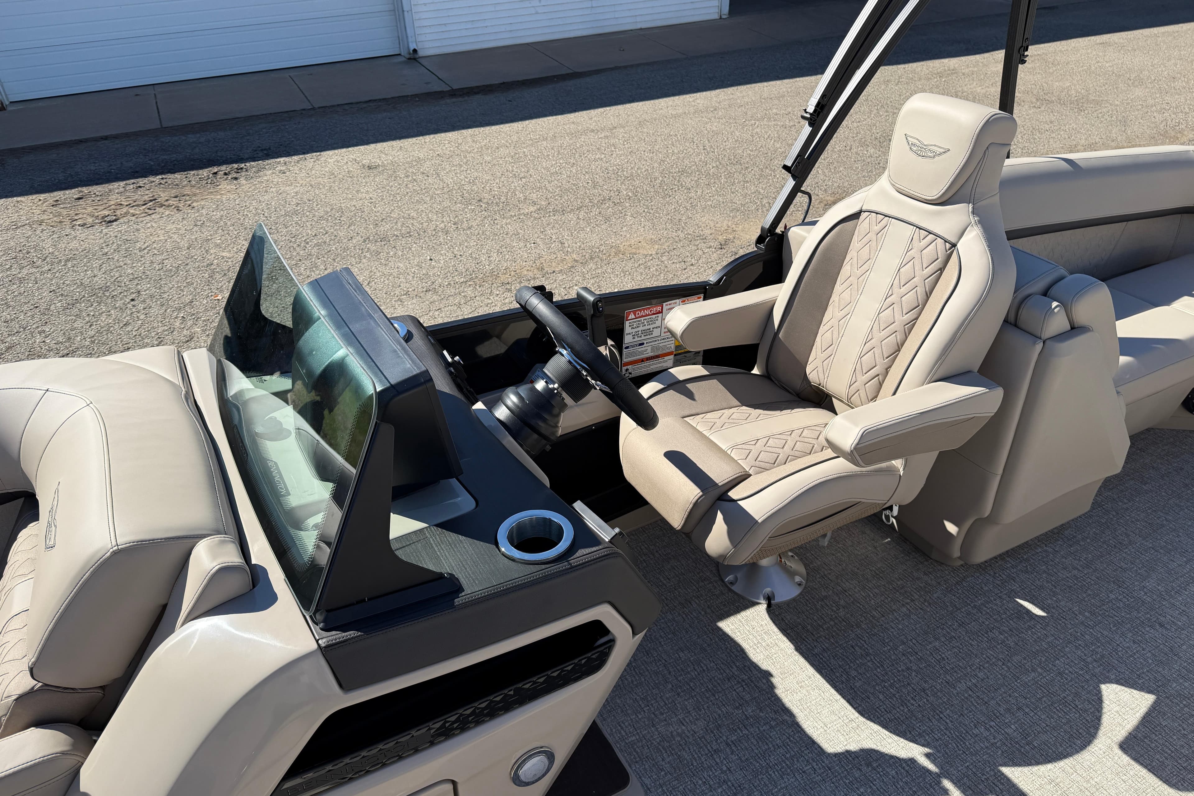 2026 Bennington 24 M Fastback boat interior with luxurious seating and modern dashboard.