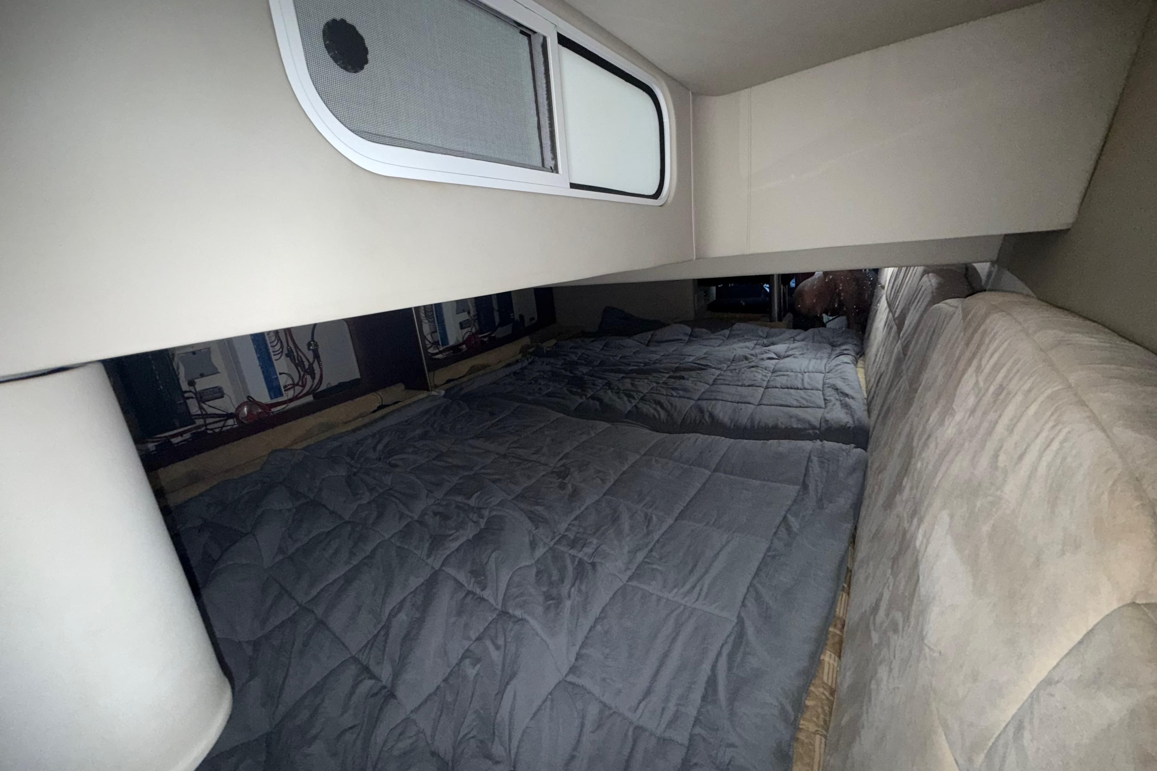 Interior cabin of 2004 Formula 370 Super Sport with cozy bedding.