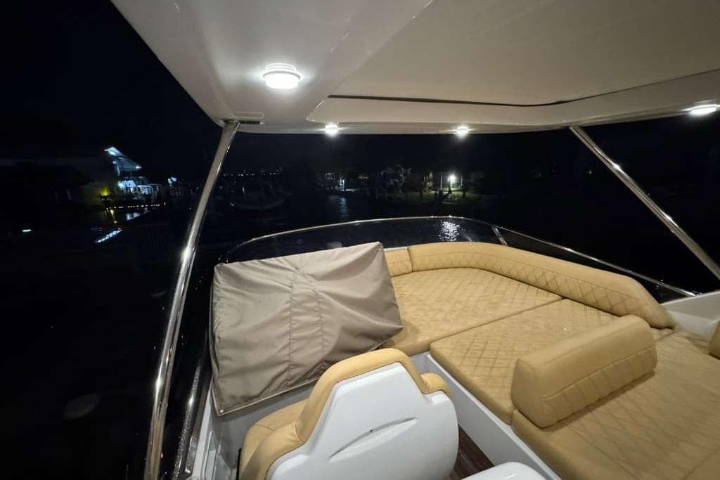 Luxurious 2014 Azimut 64 yacht interior at night with elegant seating.