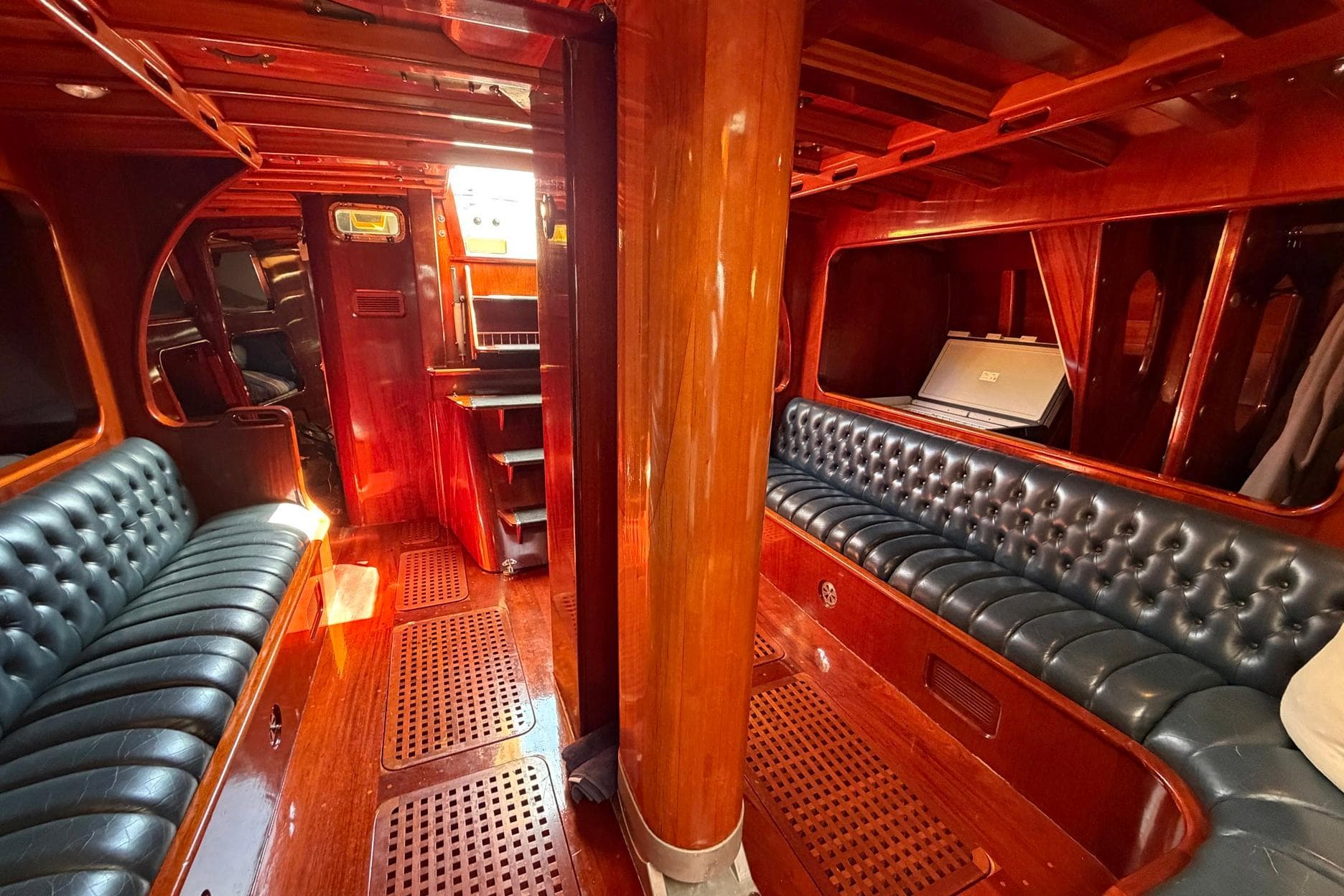 Luxurious 1992 Vic Carpenter Custom yacht interior with polished wood and leather seating.