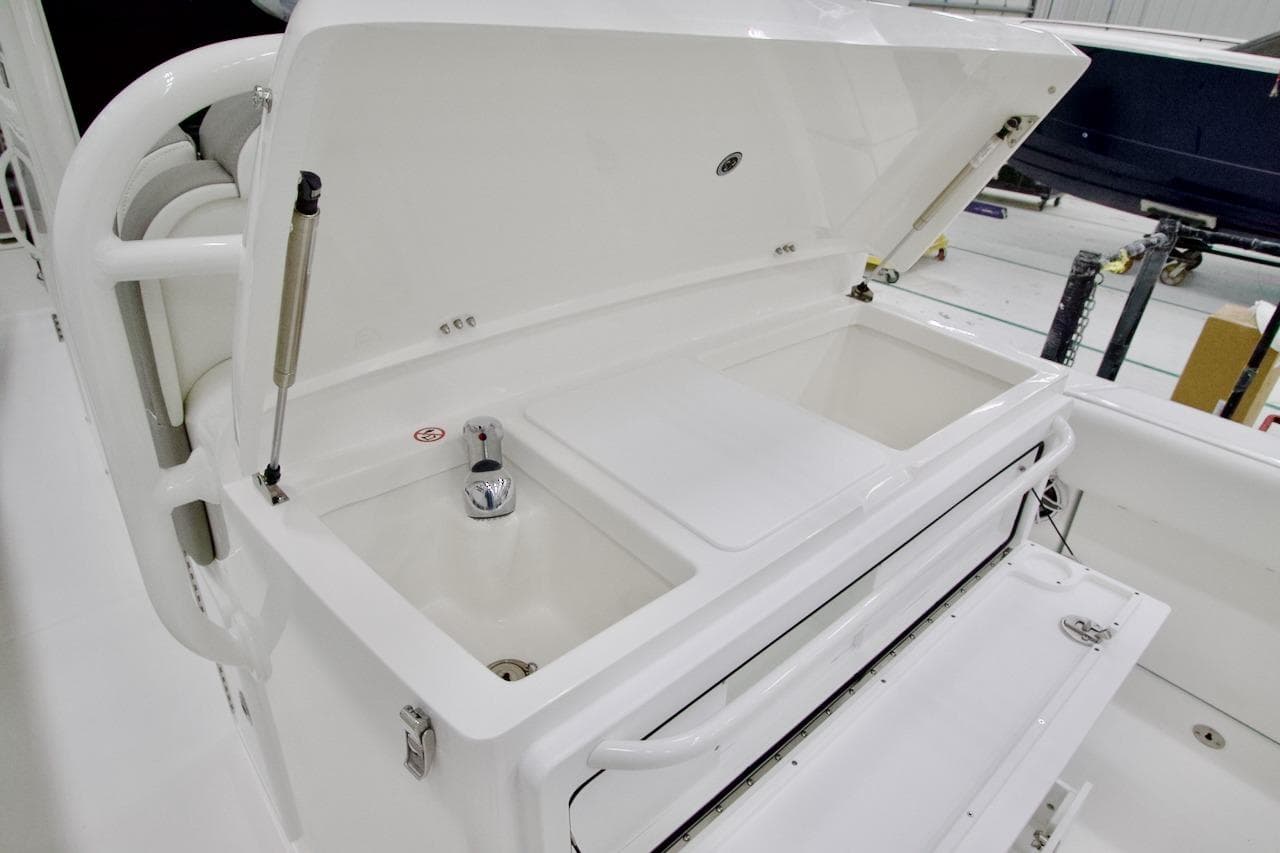 2026 Regulator 31 boat with open storage compartment and faucet in a clean, white interior.