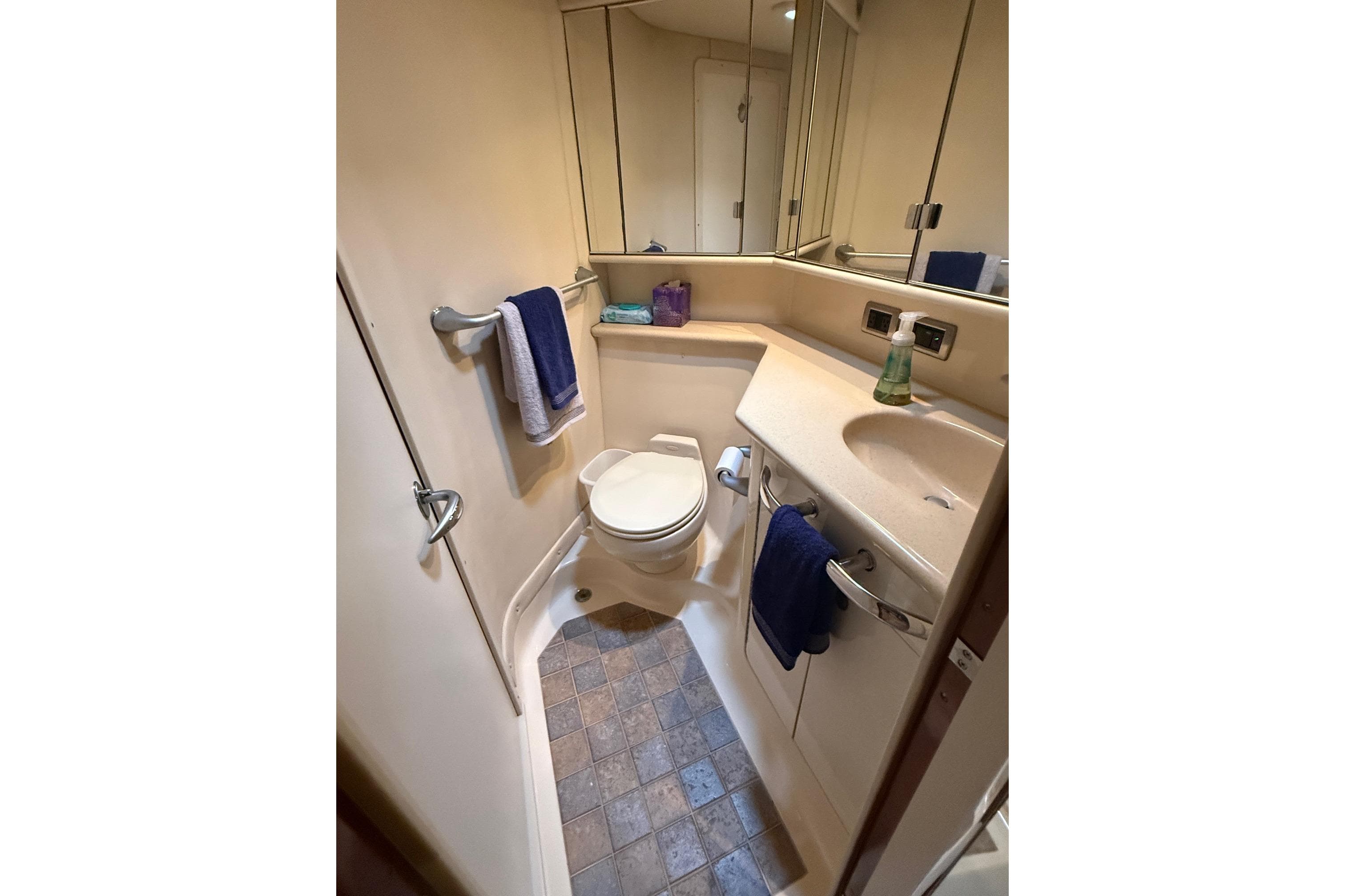 Bathroom interior of 2004 Sea Ray 550 Sundancer yacht, featuring sink and toilet.