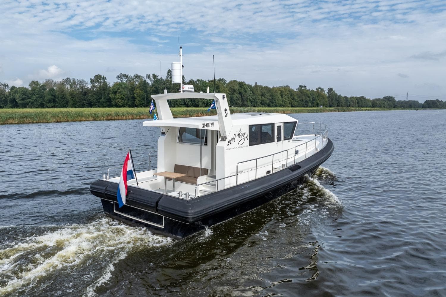 2016 Explorer NG 50 Alu Fast Going boat cruising on a river with scenic background.