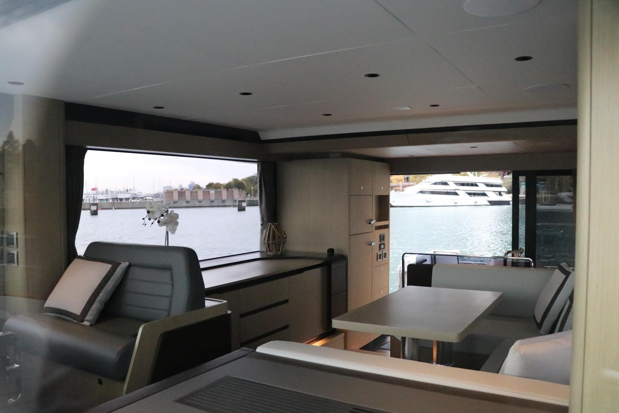 Interior of 2026 Sirena 48 Flybridge yacht with modern seating and waterfront view.