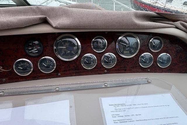 Dashboard of a 1998 Sea Ray Sundancer 330 with various gauges and controls.