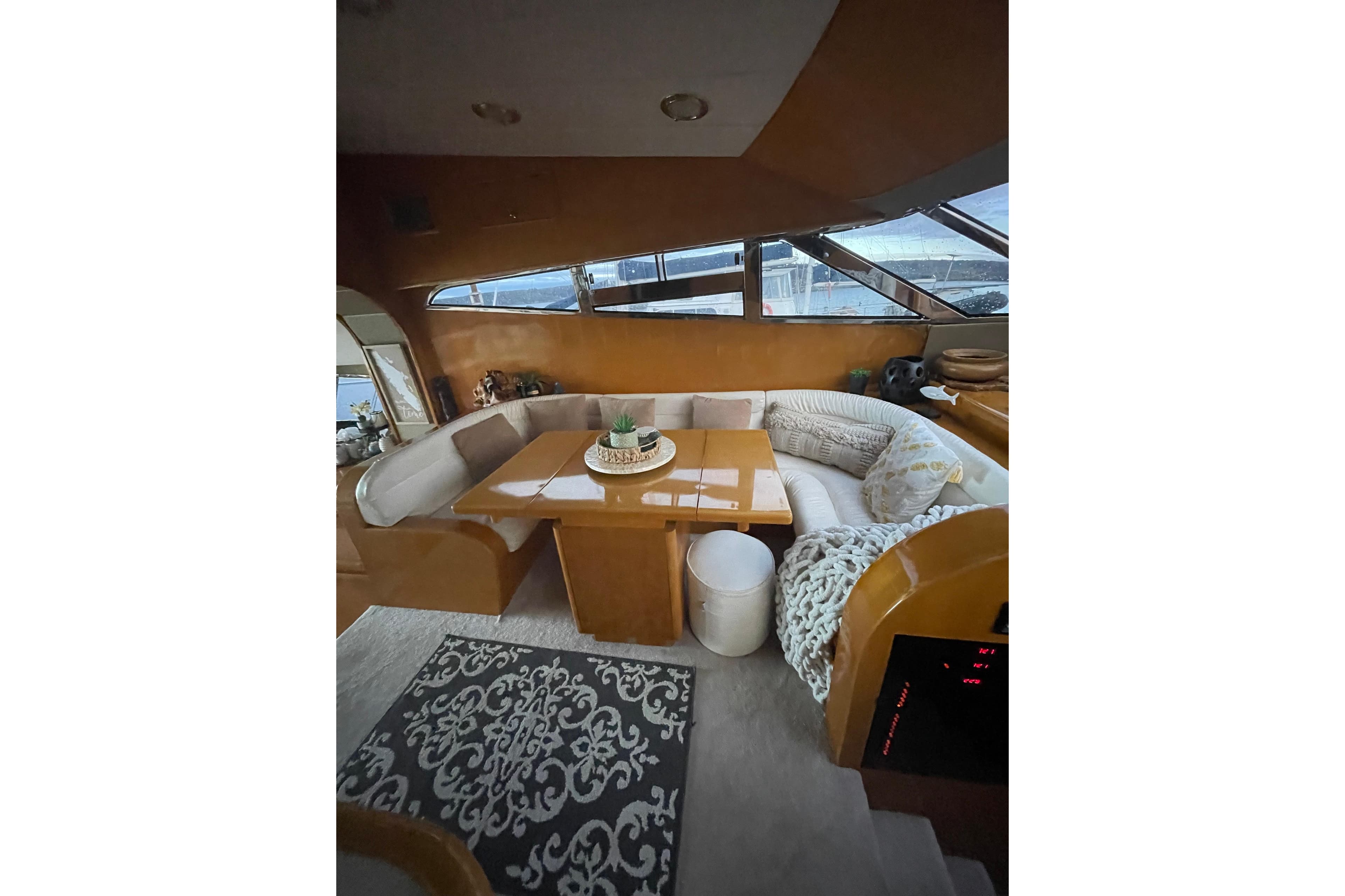 Luxurious 1994 Johnson High-Tech 65 Euro yacht interior with cozy seating and elegant decor.