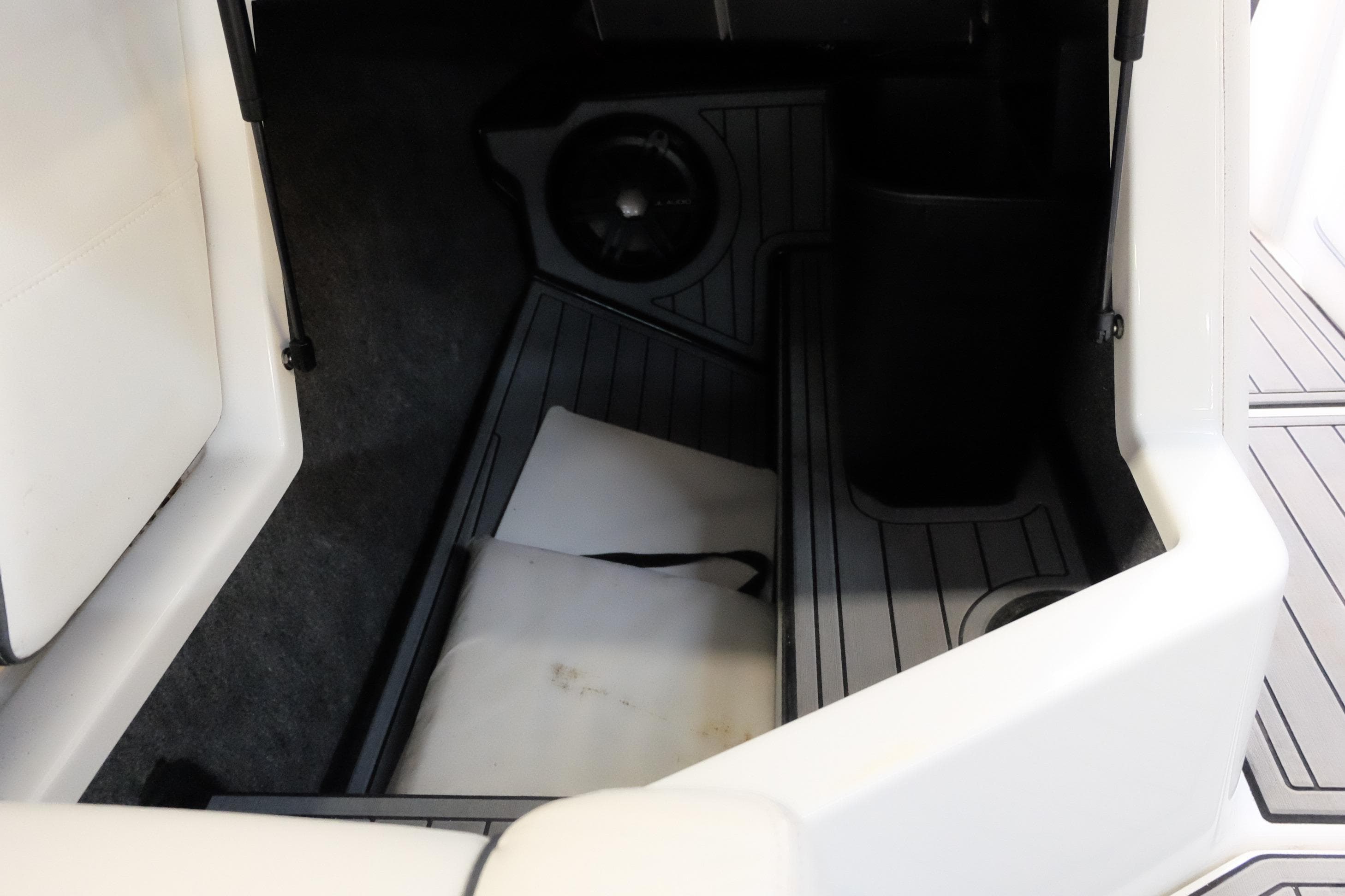 2017 Nautique Super Air Nautique G21 interior storage compartment with speaker and cushion.
