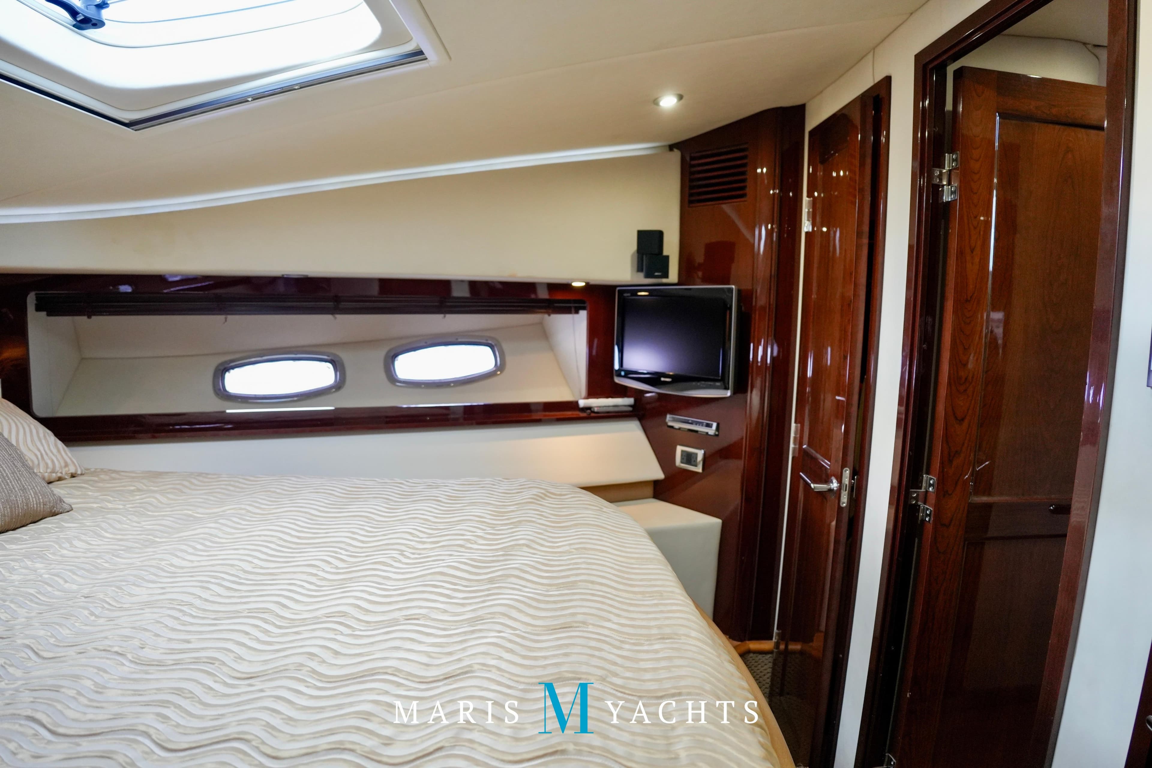 Luxurious cabin interior of 2009 Sea Ray 55 Sundancer yacht with elegant wood finishes.
