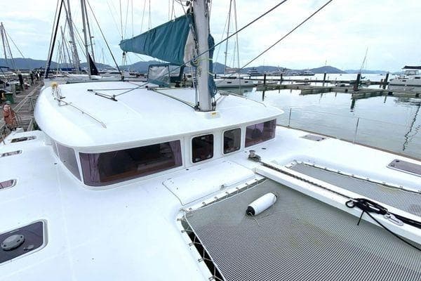 2012 Lagoon 400 catamaran docked at marina, featuring spacious deck and modern design.