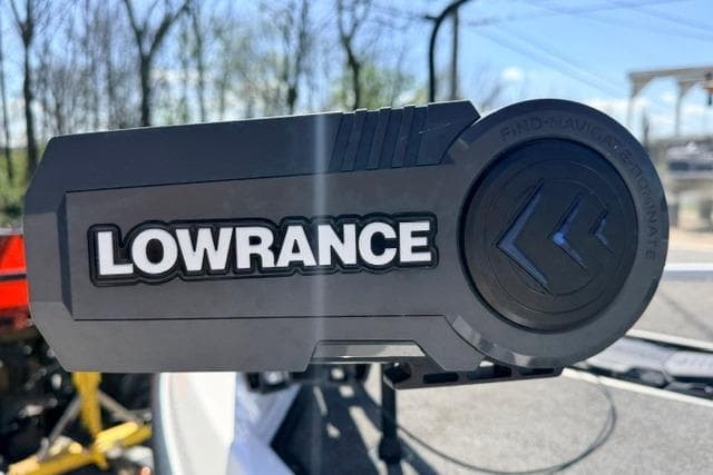 Lowrance device on 2022 Vexus VX21 boat, outdoor setting with trees in background.